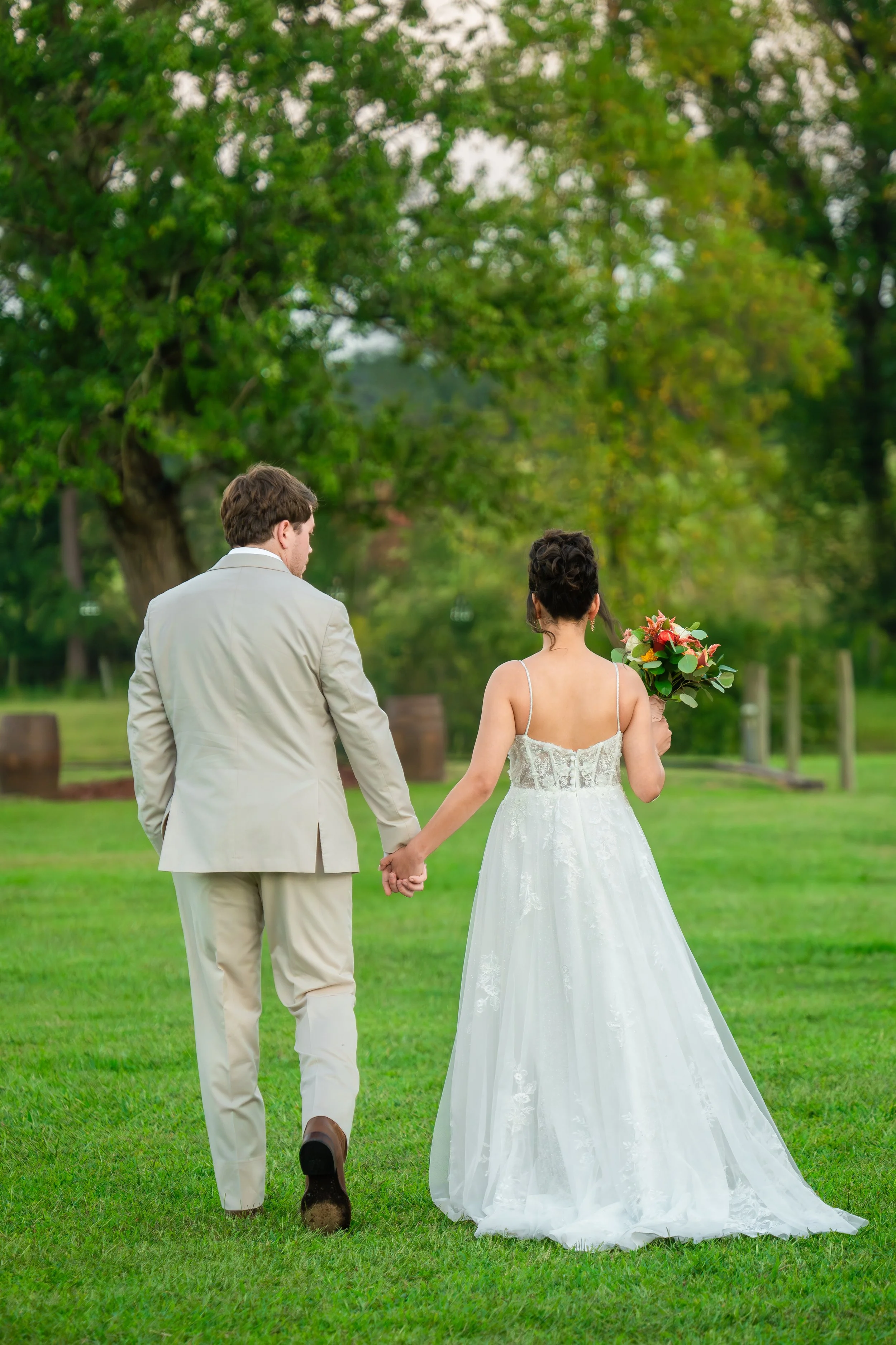 skyler-ben-wedding-couple-holding-hands-field-double-c-ranch-coats-nc.jpg