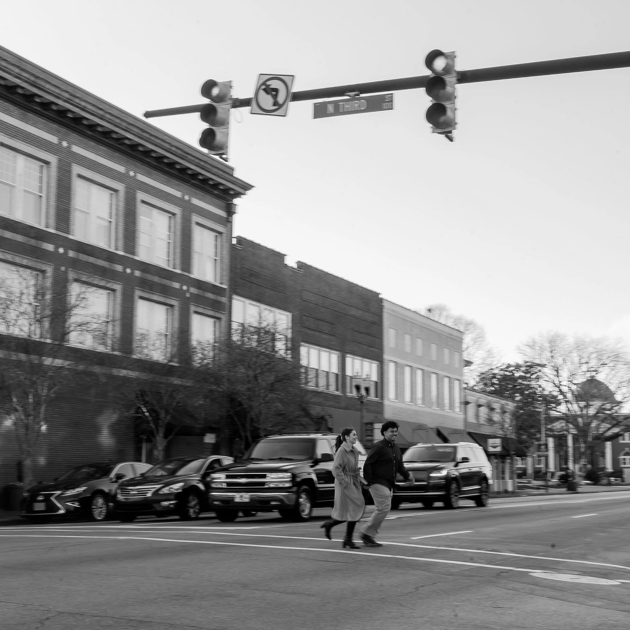 downtown-smithfield-nc-engagement-session-black-and-white-walking.jpg