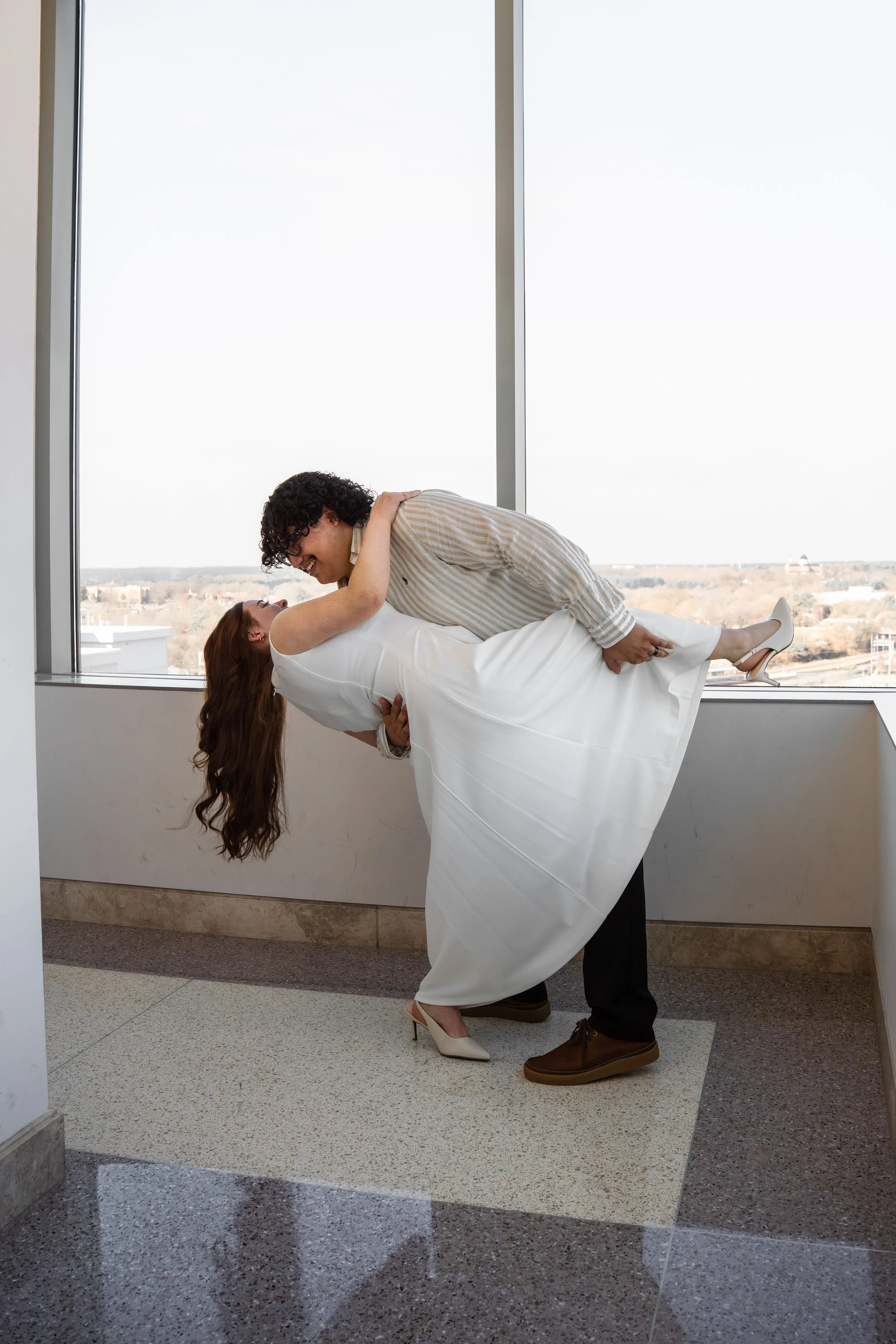 wake-county-justice-center-civil-wedding-raleigh-nc-window-dip-kiss.jpg