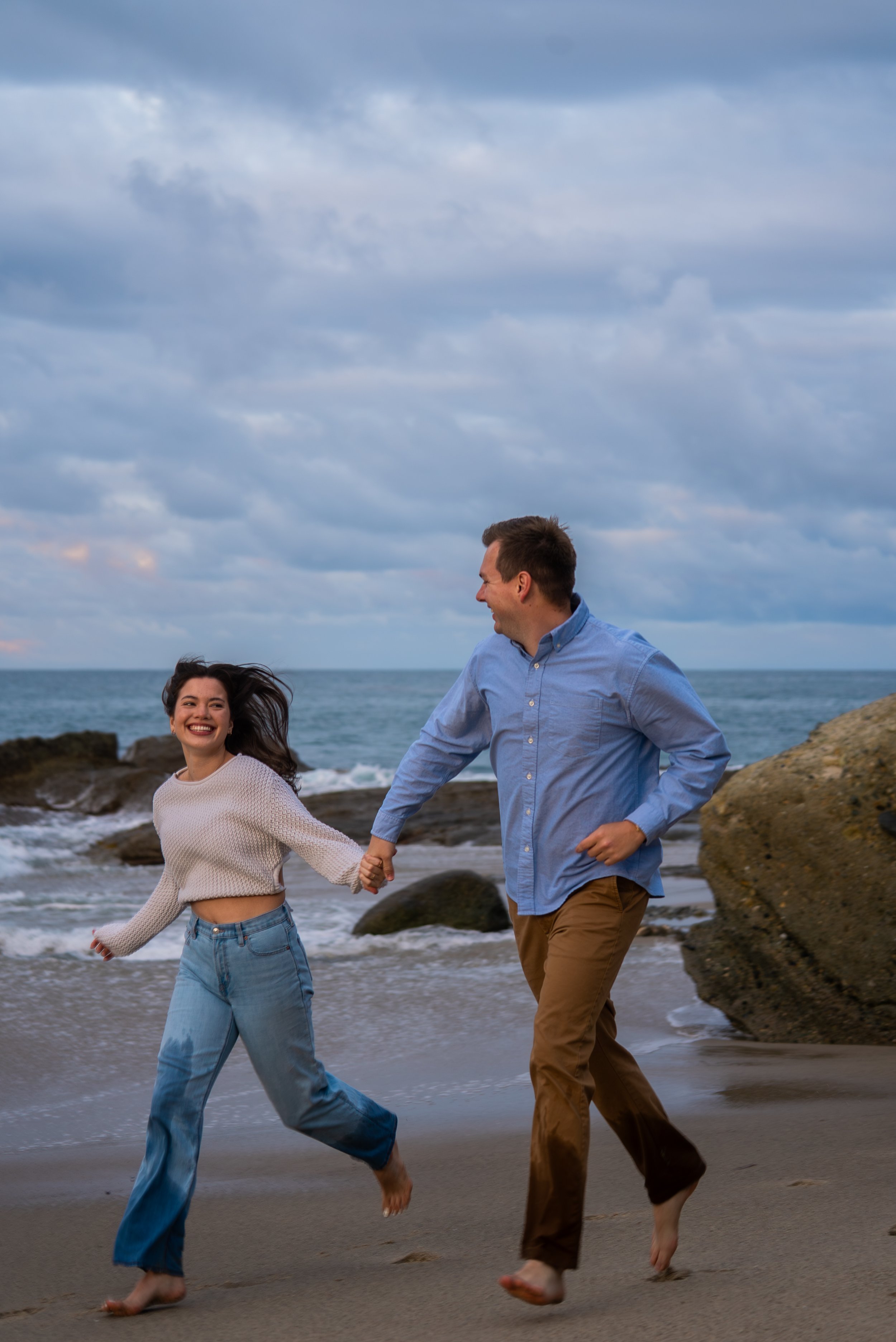 laguna-beach-couples-photographer-running-together.jpg