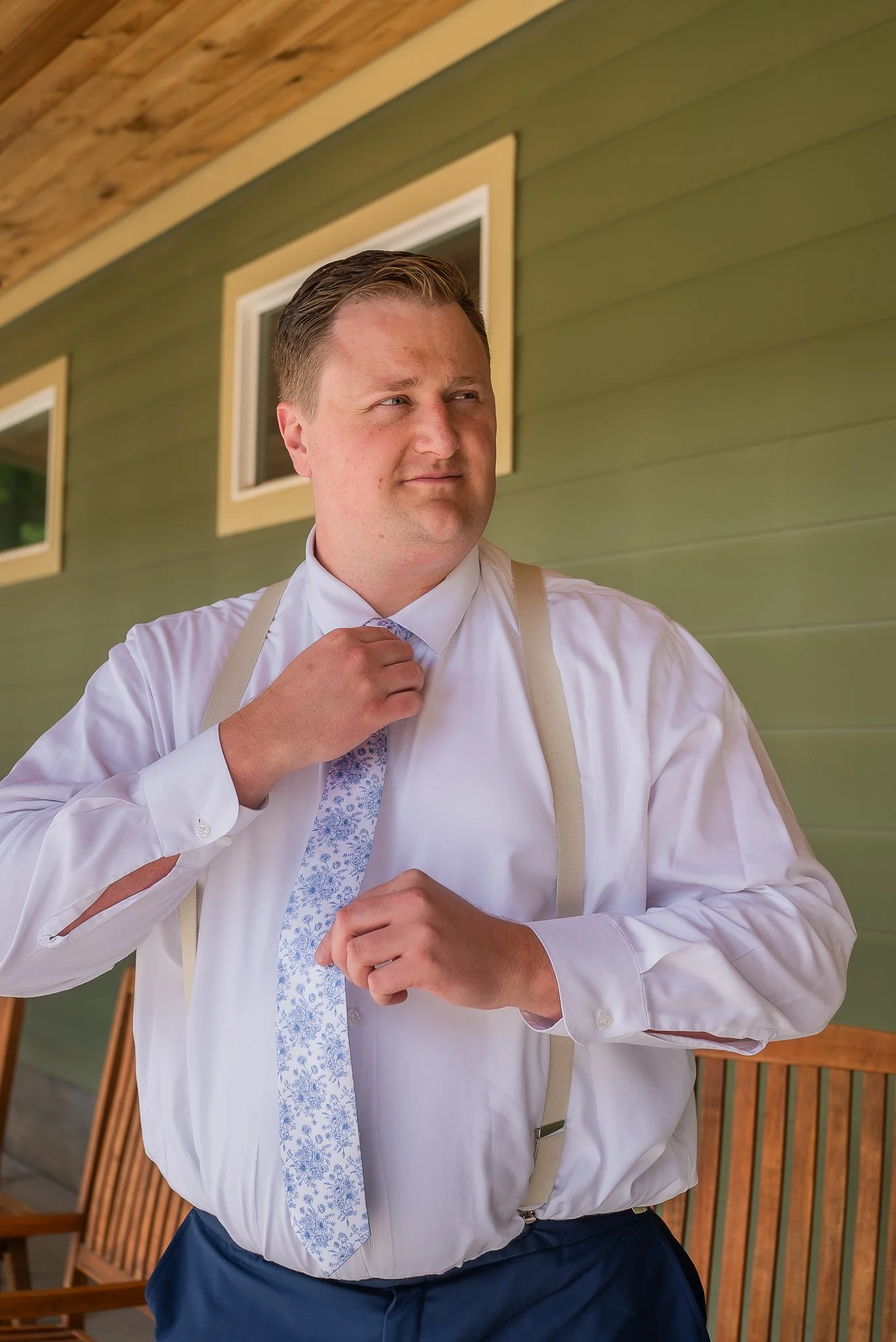 john-groom-getting-ready-buttoning-shirt-mini-acre-farms-raleigh-nc.jpg