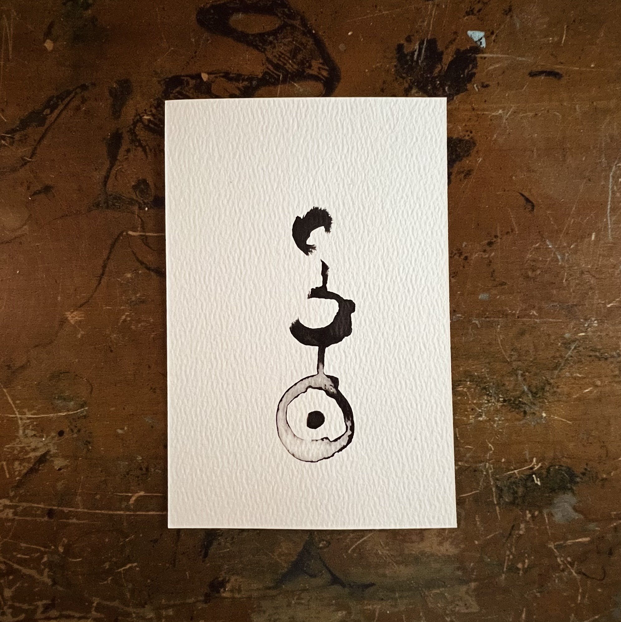 Ink and water illustration. Simple black ink free-form intuitive brush stroke shapes. depicting the inkeyed studios emblem.