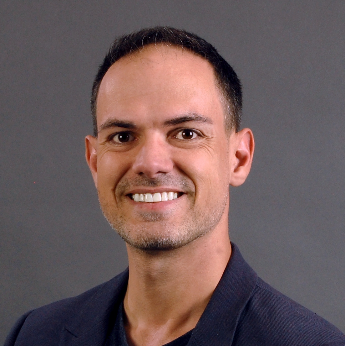 A headshot of Dr. Joshua Hillman smiling.