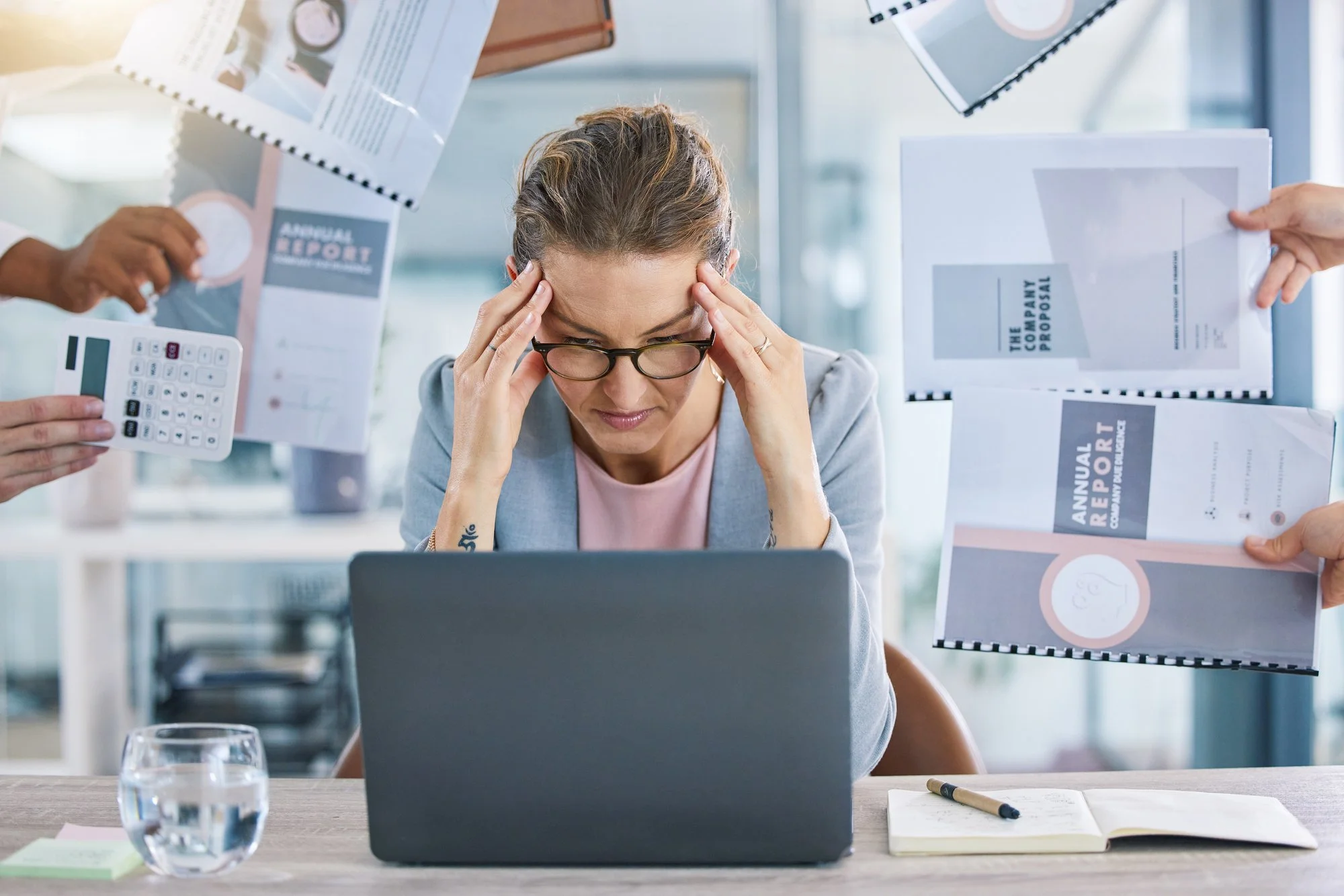 overwhelmed looking woman with laptop