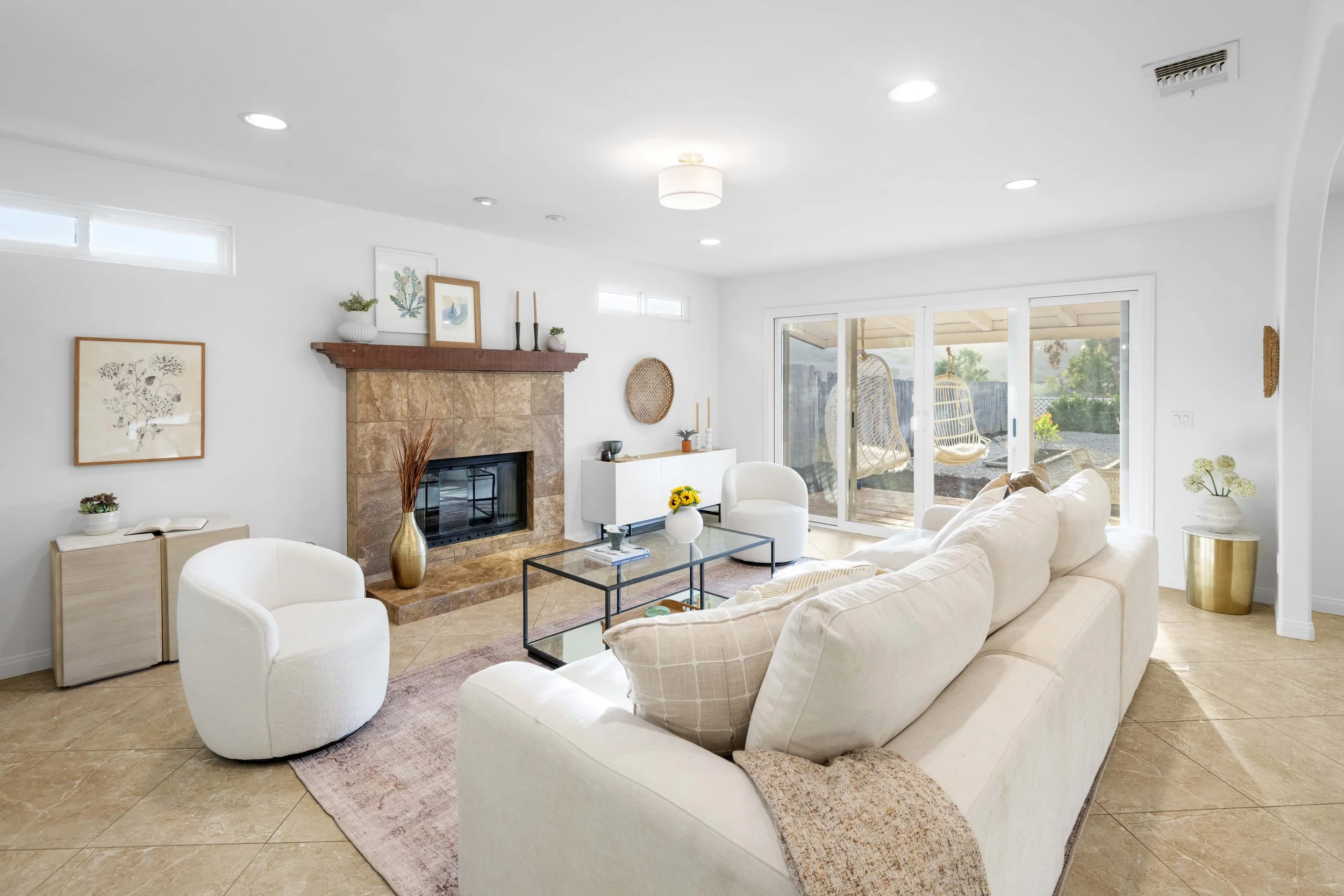 Bright living room with sliding glass door to patio — LA property photographed by Intuition Real Estate Media to showcase indoor-outdoor lifestyle.