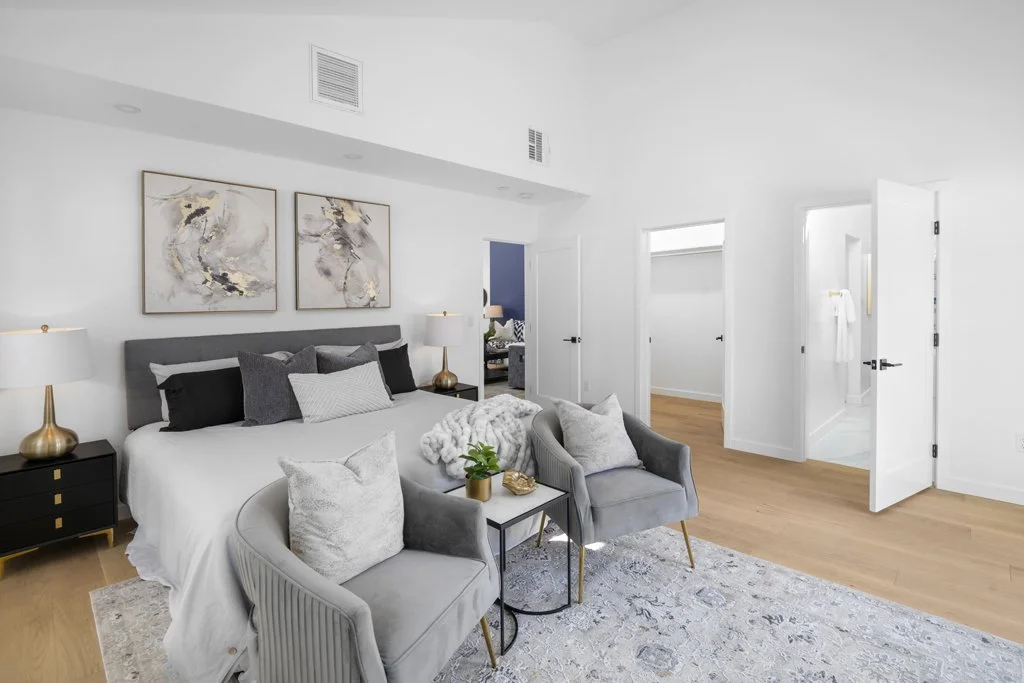 Best bedroom photography in Los Angeles – elegant staging with gold-accented lamps, beige rug, and gray armchairs. Captured by Intuition Real Estate Media.