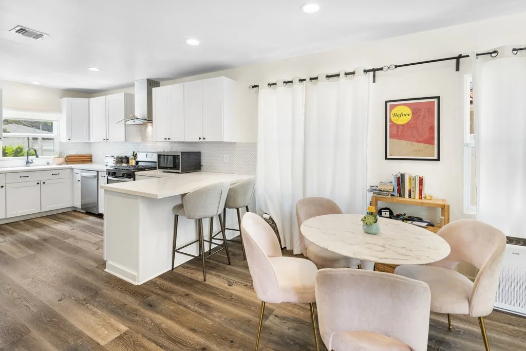 Interior real estate photo of kitchen and dining area with pastel accents – affordable Los Angeles real estate photography by Intuition Real Estate Photography & Imaging.