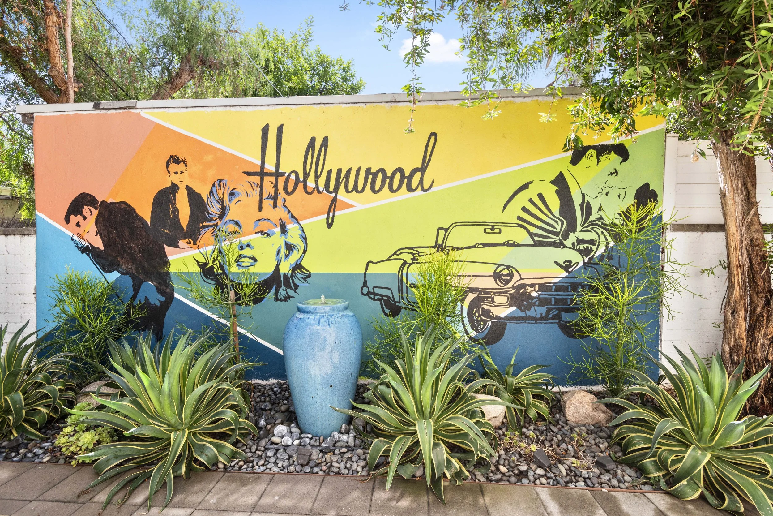 Vibrant Los Angeles mural with classic car and ‘Hollywood’ typography — perfect for neighborhood lifestyle branding by Intuition Real Estate Media.