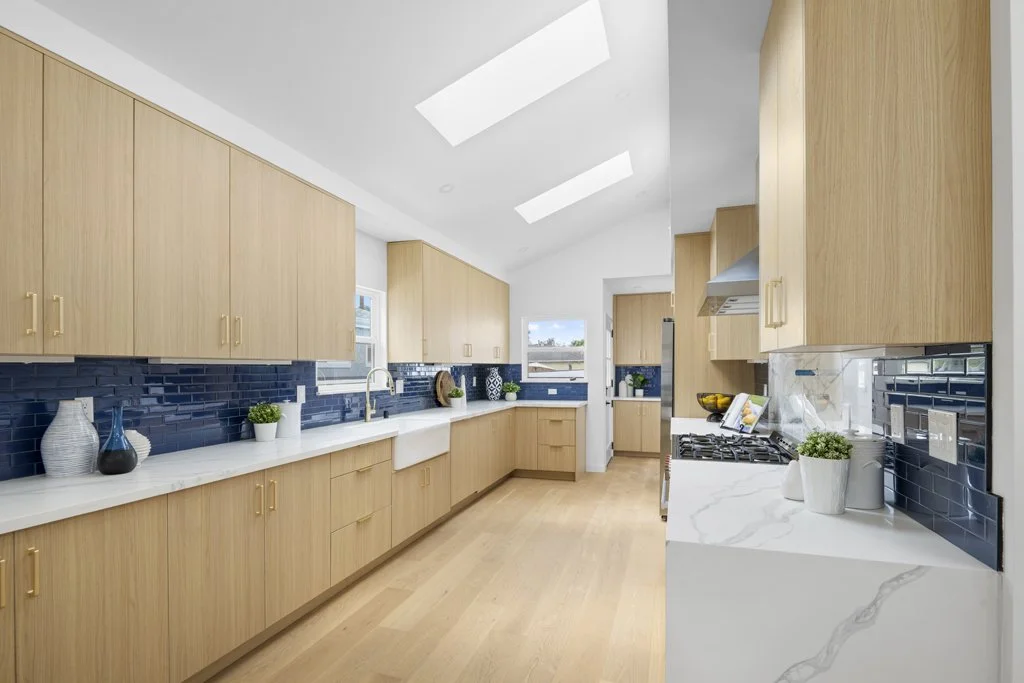 Best real estate kitchen photography in Los Angeles – light wood cabinets, black tile backsplash, and farmhouse sink, shot by Intuition Real Estate Media.