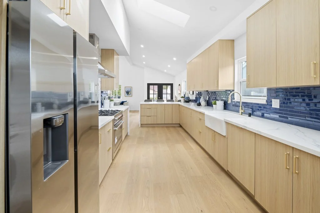 Affordable Los Angeles real estate kitchen photo – modern design with blue backsplash, stainless appliances, and bright lighting by Intuition Real Estate Photography & Imaging.