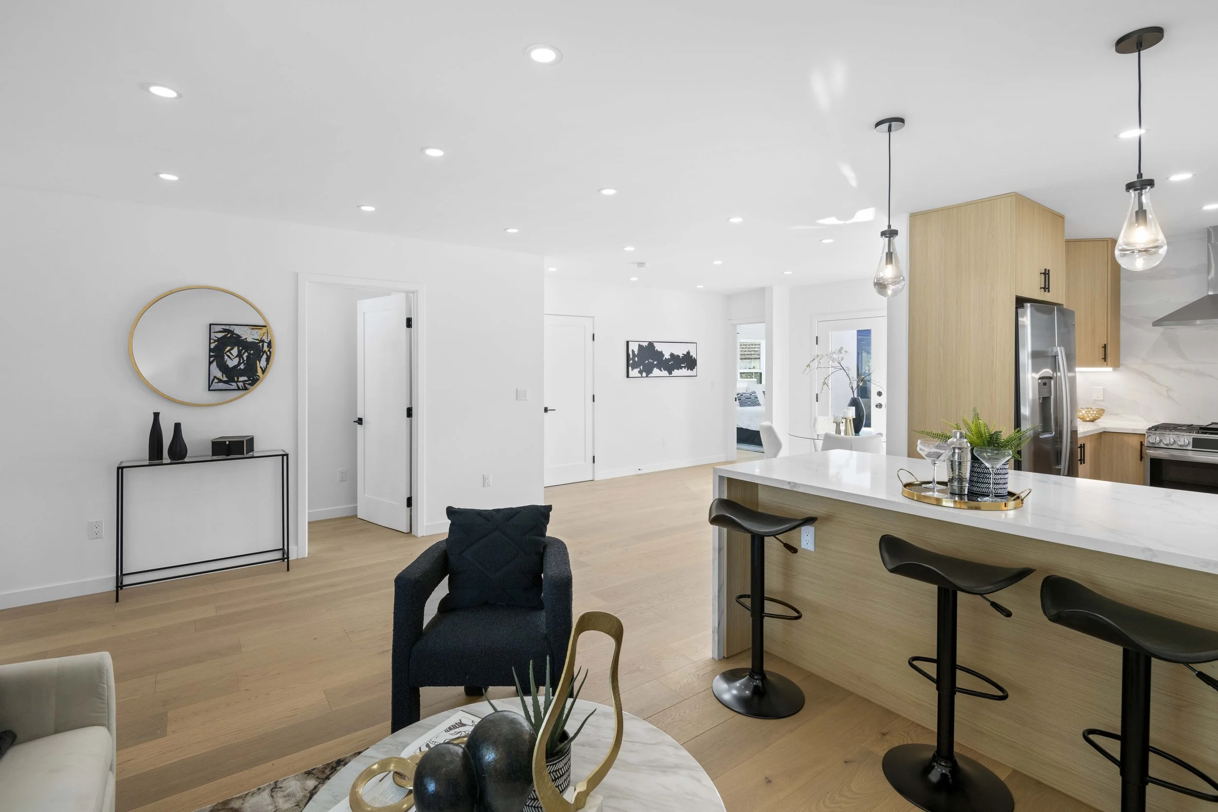 Open-concept LA home with kitchen island, modern finishes, and staging by Intuition Real Estate Media — perfect for luxury real estate listings and walkthroughs.