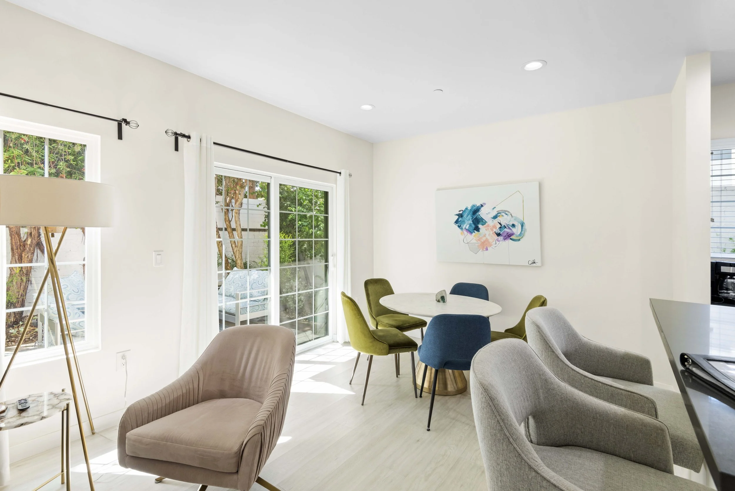 Open living space with colorful chairs and patio view — interior listing photography by Intuition Real Estate Photography & Imaging in Los Angeles.