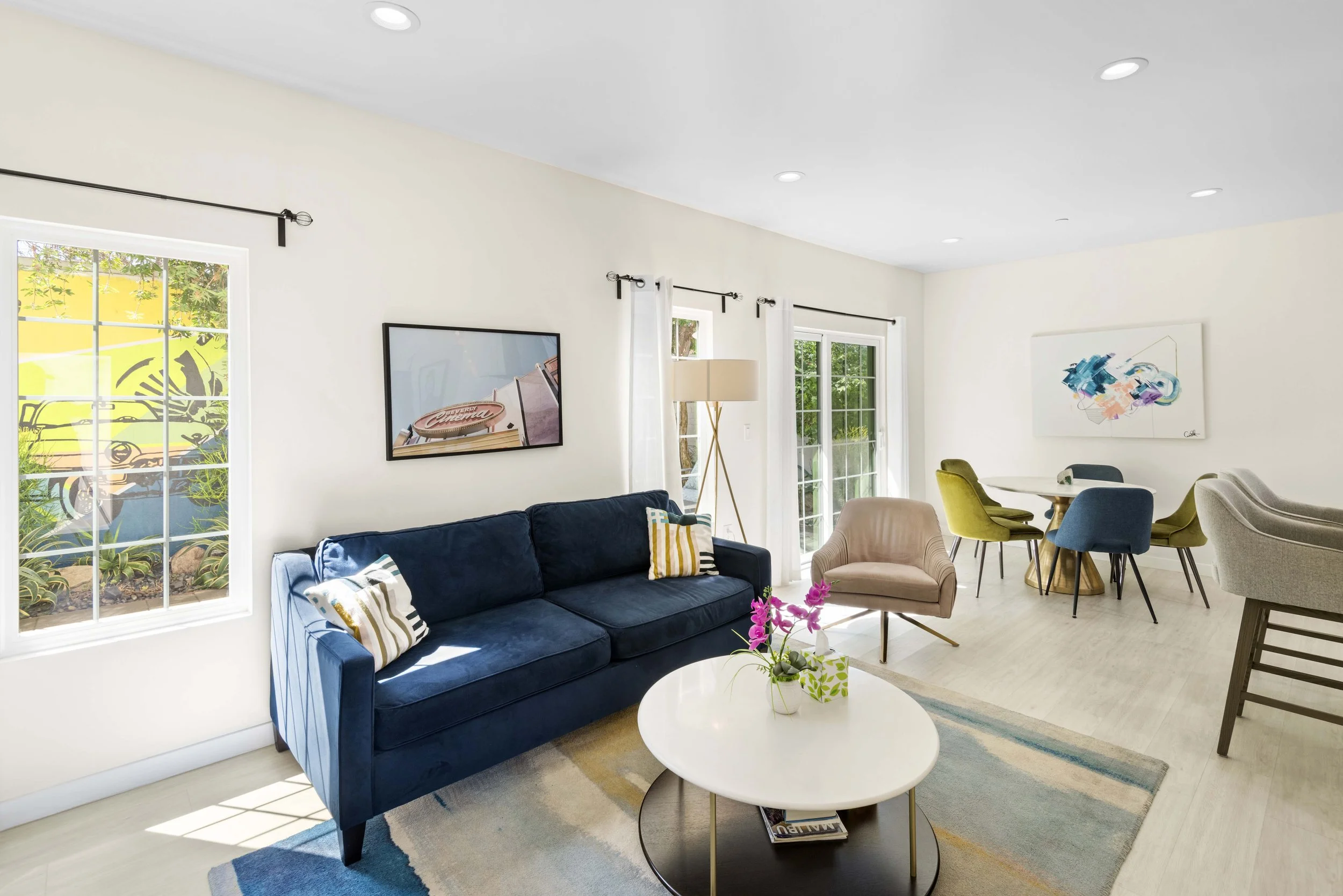 Bright Los Angeles living room with navy sofa and natural light — professionally photographed by Intuition Real Estate Media for top-performing property listings.
