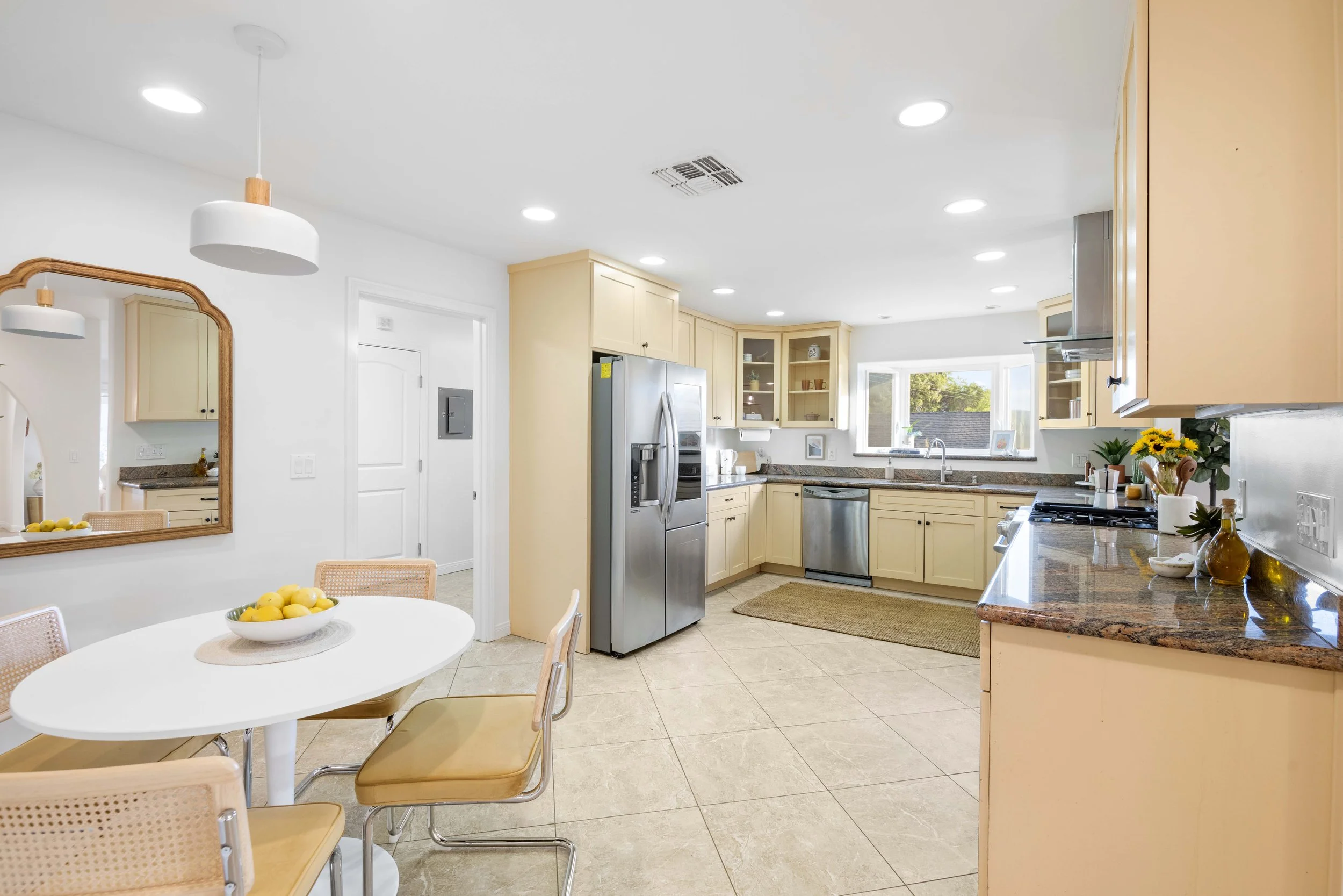 Beige kitchen with stainless appliances and lemon decor — interior listing photo by Intuition Real Estate Photography & Imaging, Los Angeles.