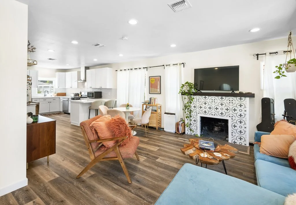 Teal sectional living room with patio view – professionally photographed in Los Angeles by Intuition Real Estate Media for home listings and interior design marketing.