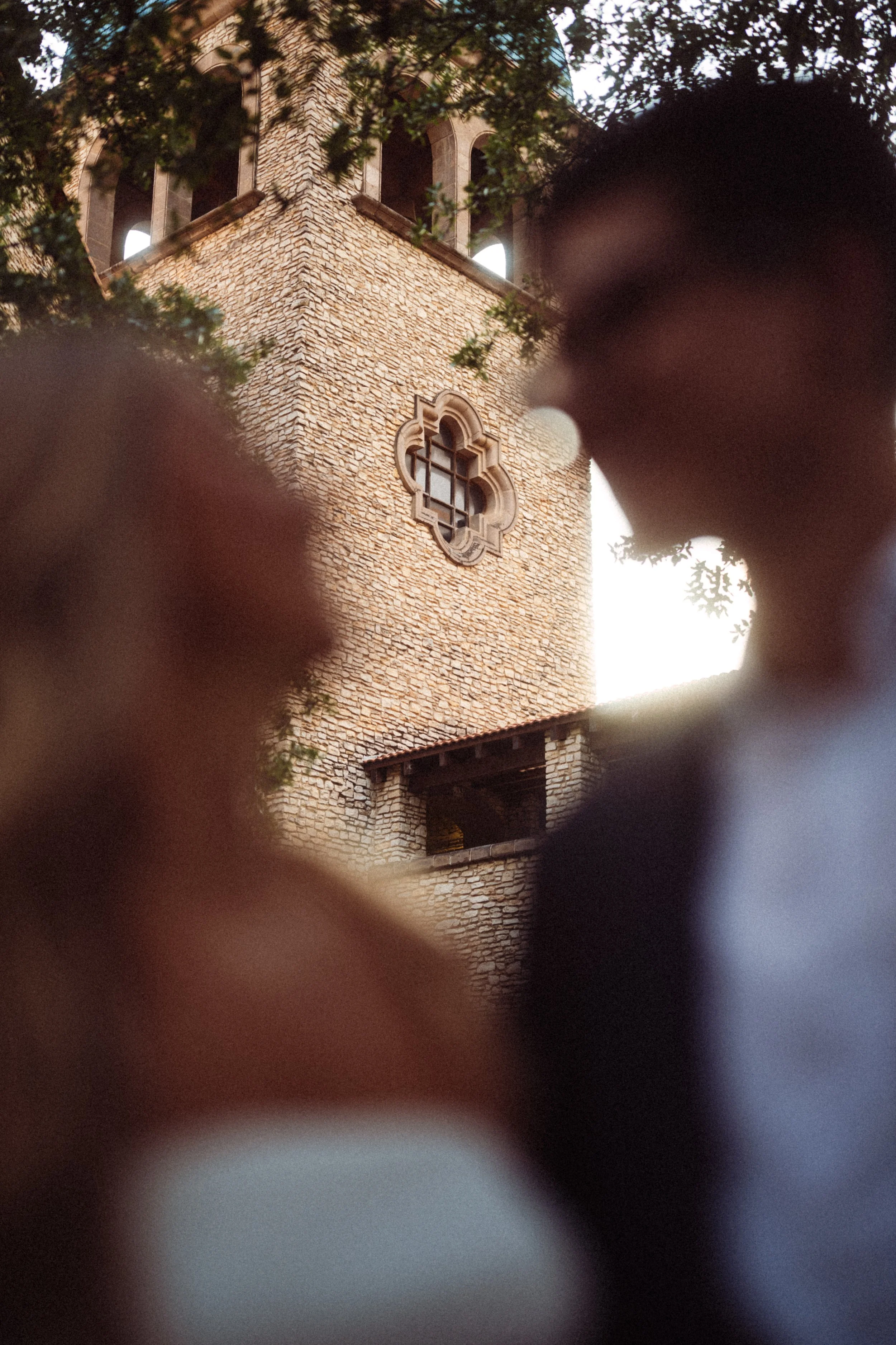  A cinematic  engagement photo silhouette  capturing Andres and Alaina during  golden hour  at the  Mandalay Canal in Irving, Texas . The couple is artfully blurred against the iconic  European stone architecture  and warm  sunset backlight , showcas