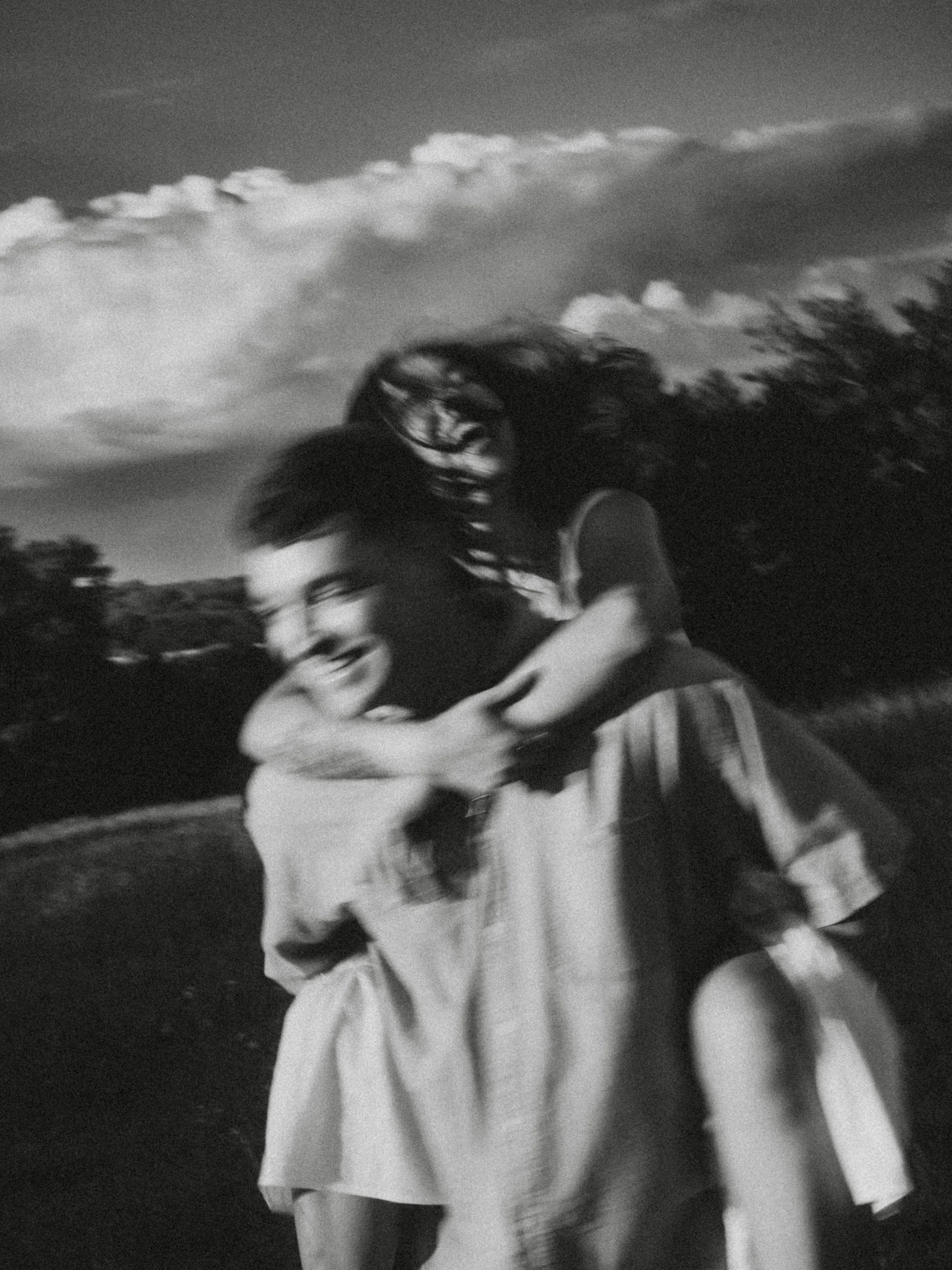  Authentic, blurry black and white piggyback ride reflecting a candid documentary style at  Erwin Park in McKinney . 
