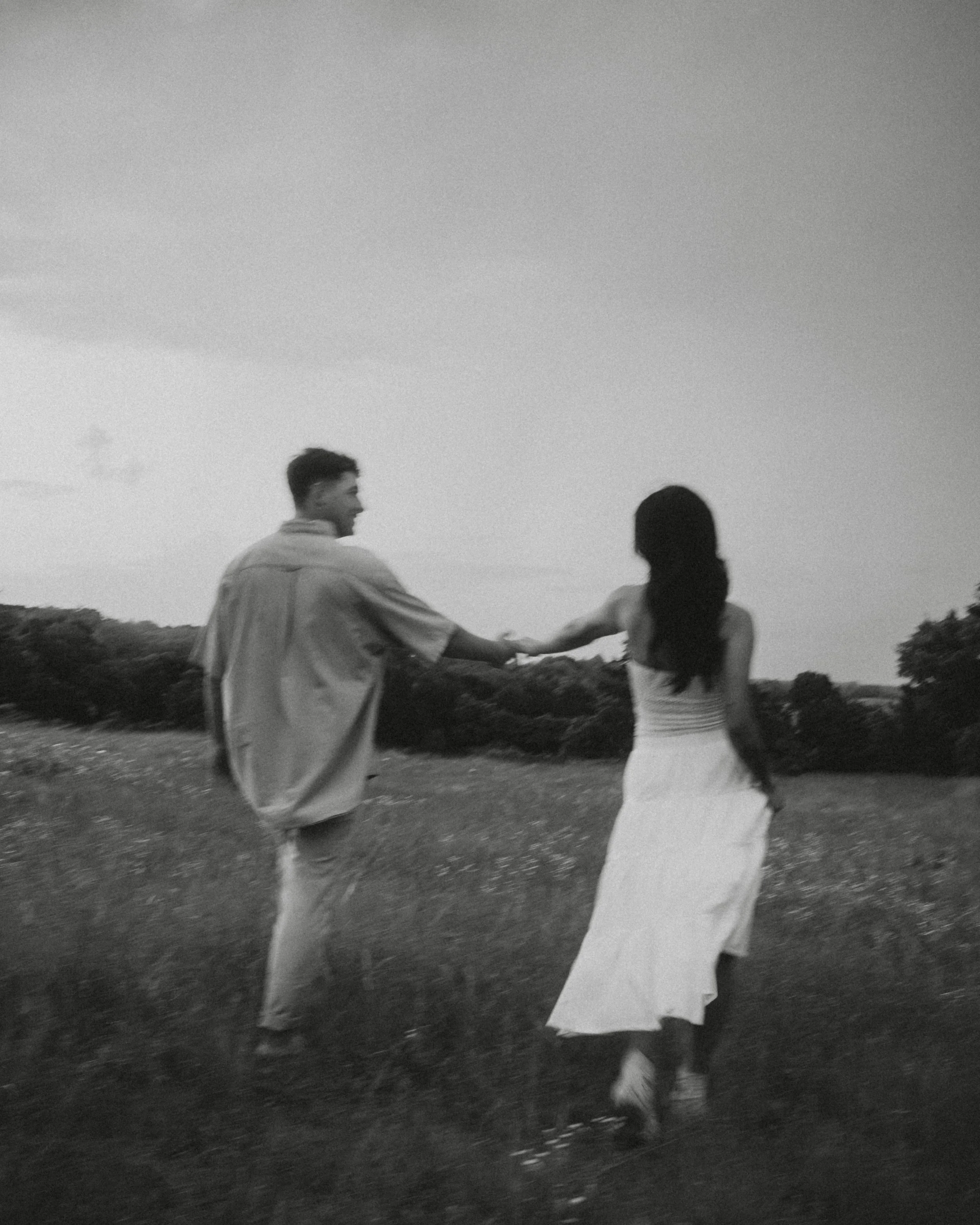  Intimate black and white portrait of a couple walking a nature trail at dusk at  Erwin Park in McKinney . 