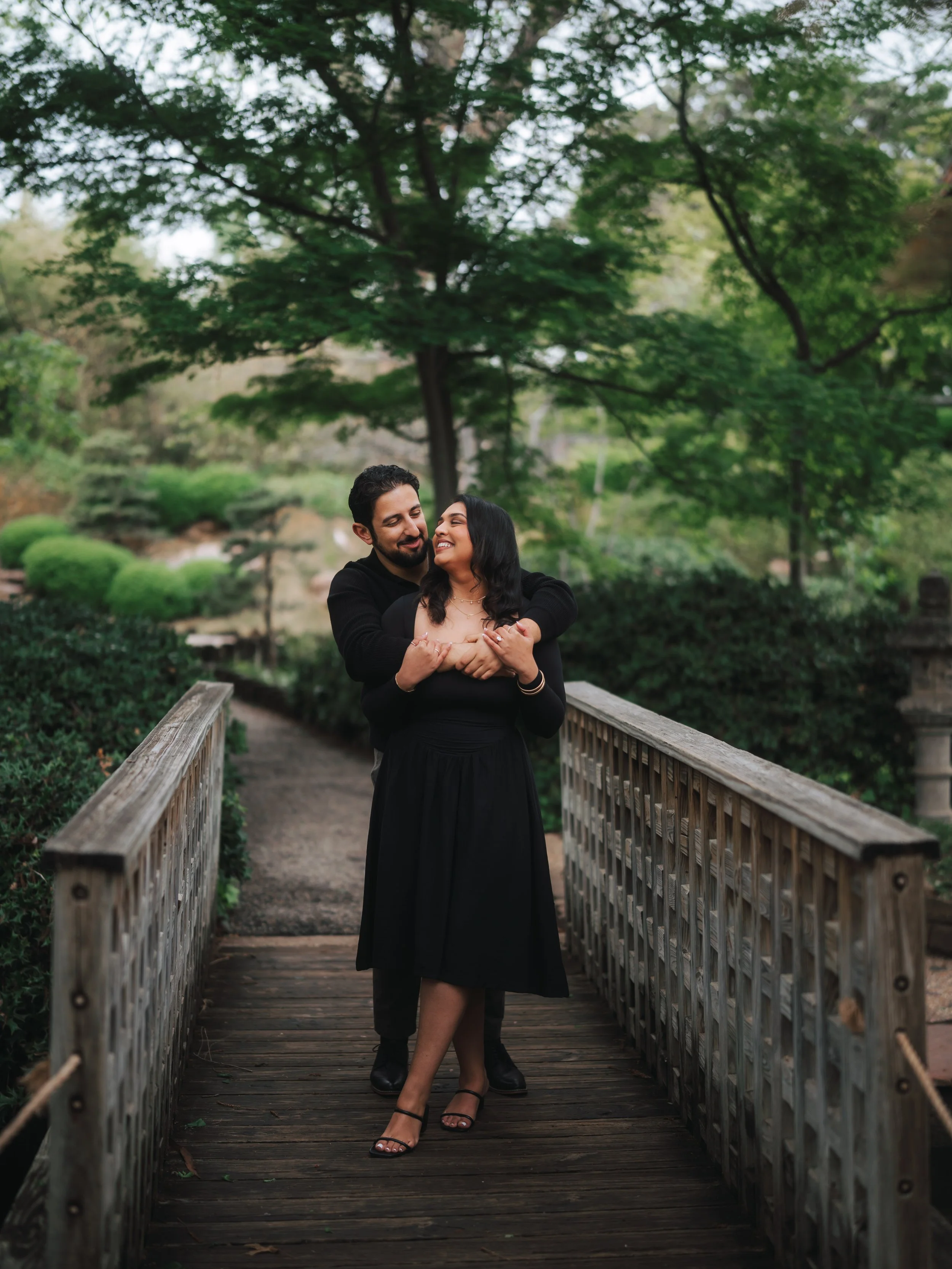  Romantic engagement portrait of Jad and Loana on a wooden bridge at the Fort Worth Botanic Garden Japanese Garden. 