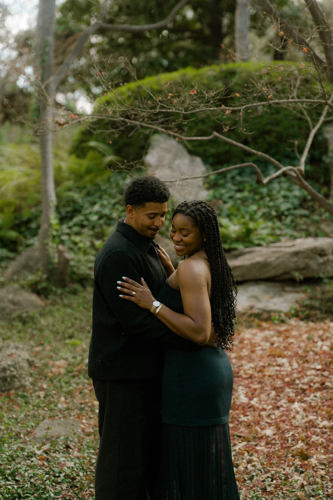 engaged-couple-embrace-garden.jpg