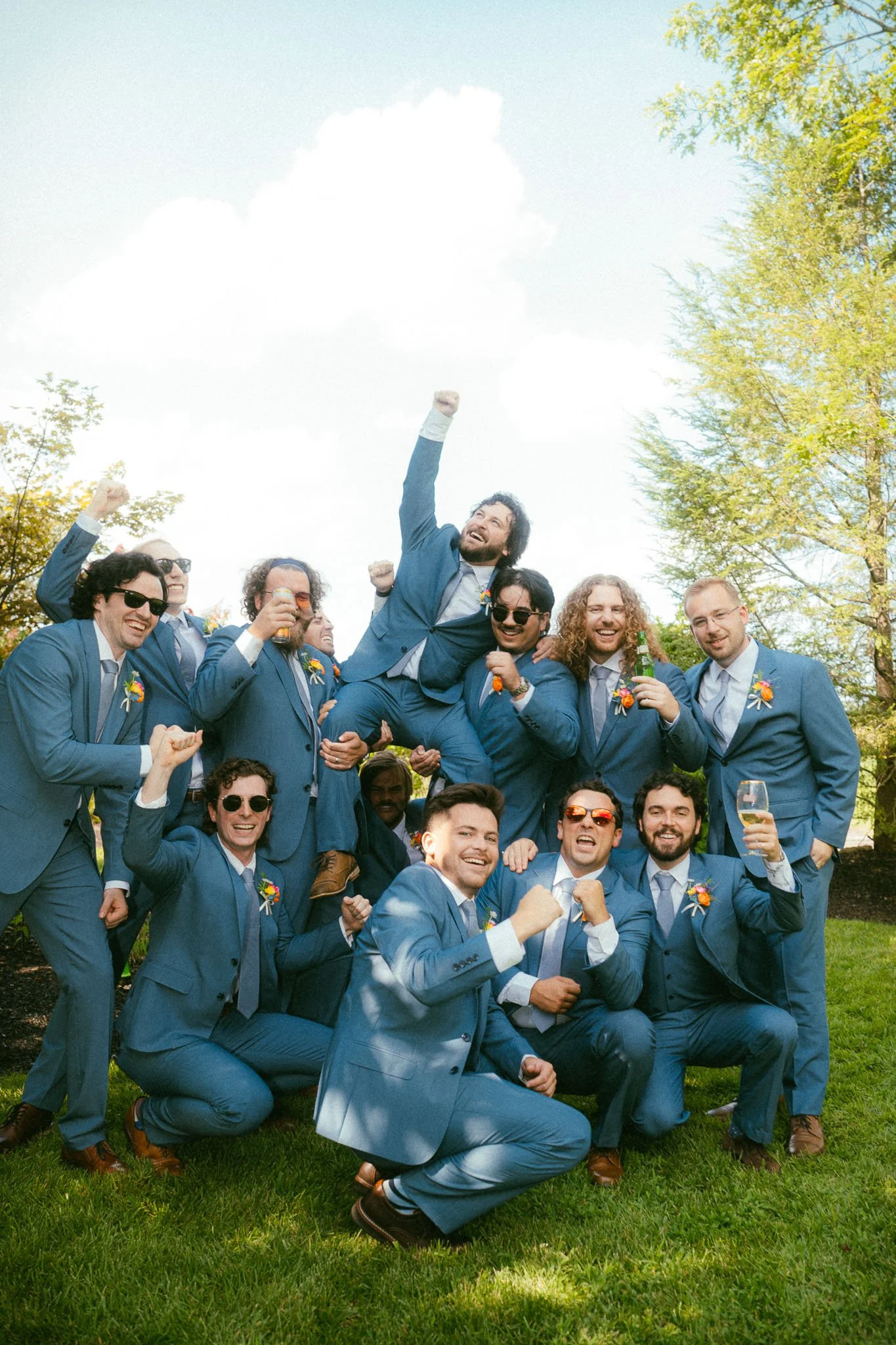groomsmen-lifting-groom-blue-suits.jpg