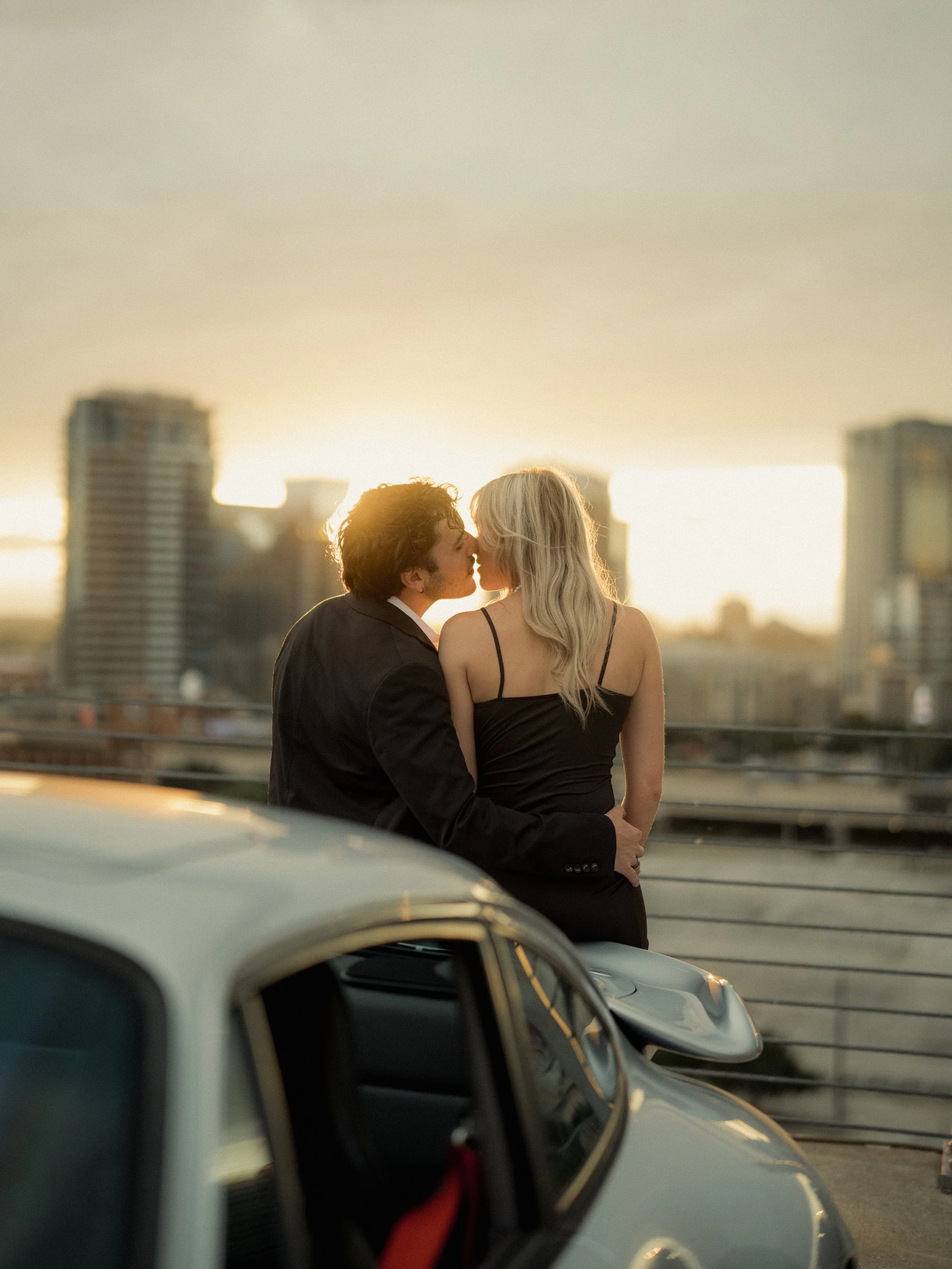 sunset-rooftop-couple-kissing-downtown-skyline.jpg