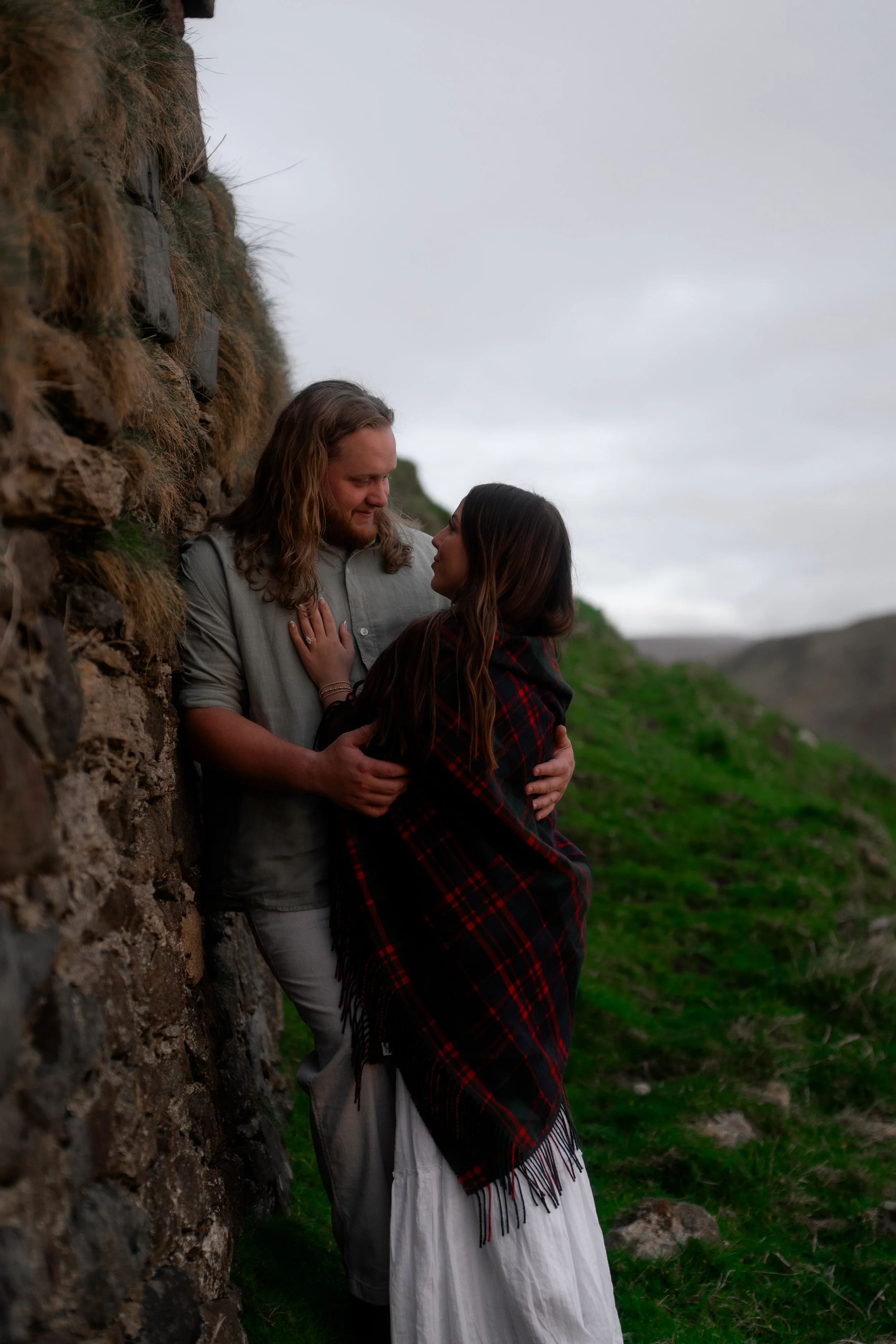 authentic-couple-embrace-ancient-stone-wall-scotland.jpg