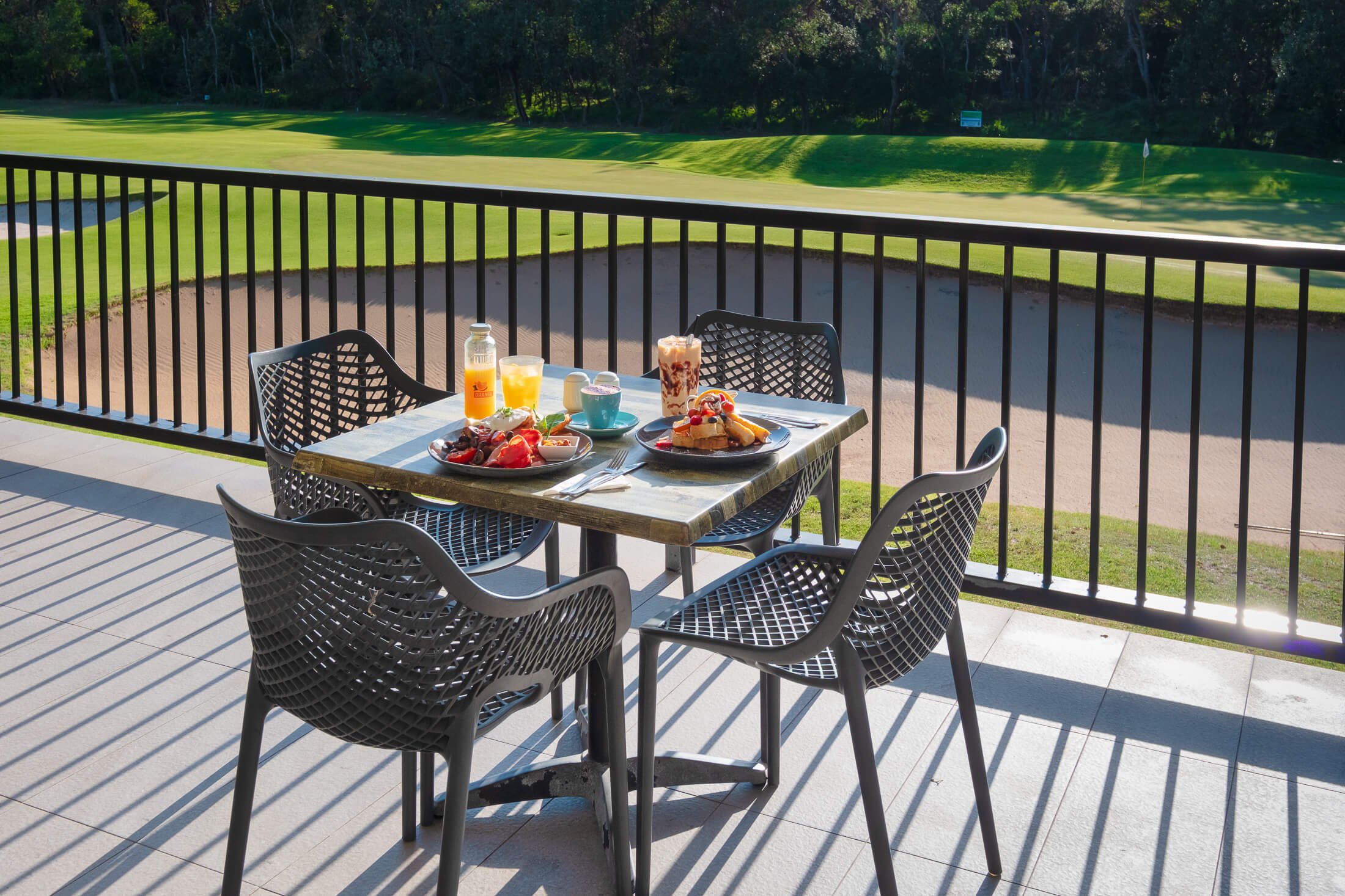 Outdoor dining table on the clubhouse deck overlooking the golf course at Shoalhaven Heads Golf Club