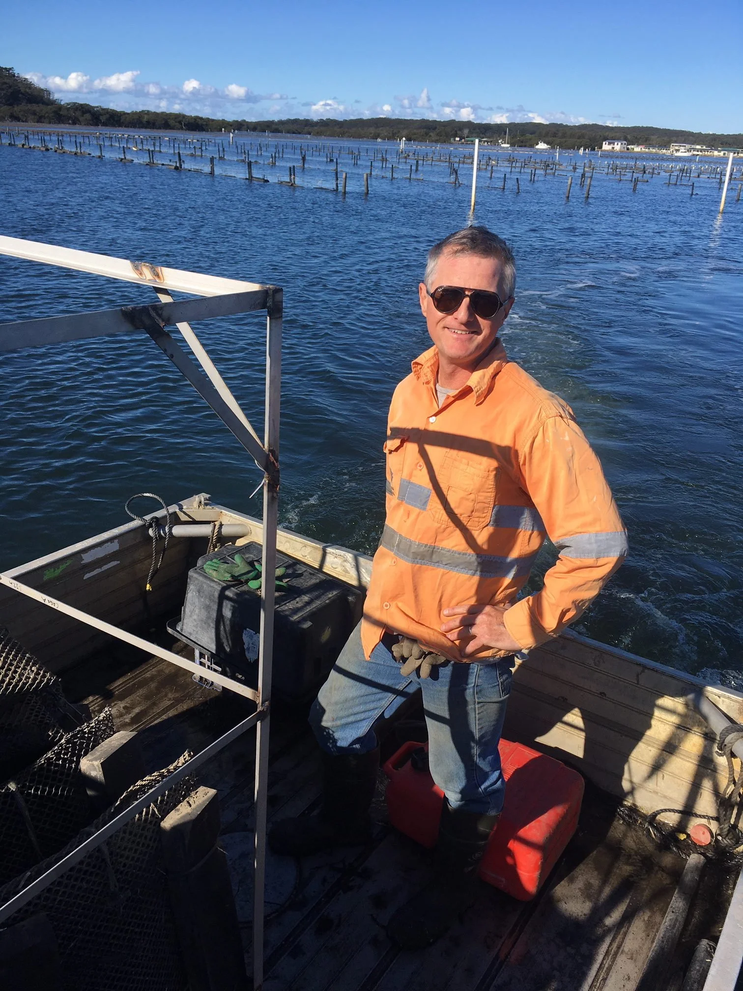 Bel's Oysters co-owner James Williams on his oyster punt among the leases on the Shoalhaven River