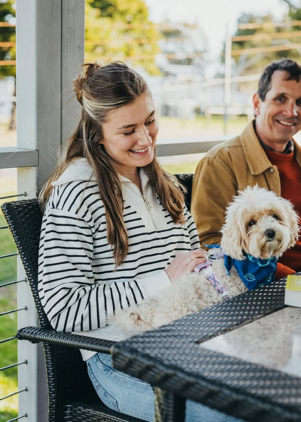Holiday-Haven-woman-with-dog-on-lap-on-cabin-porch.jpg