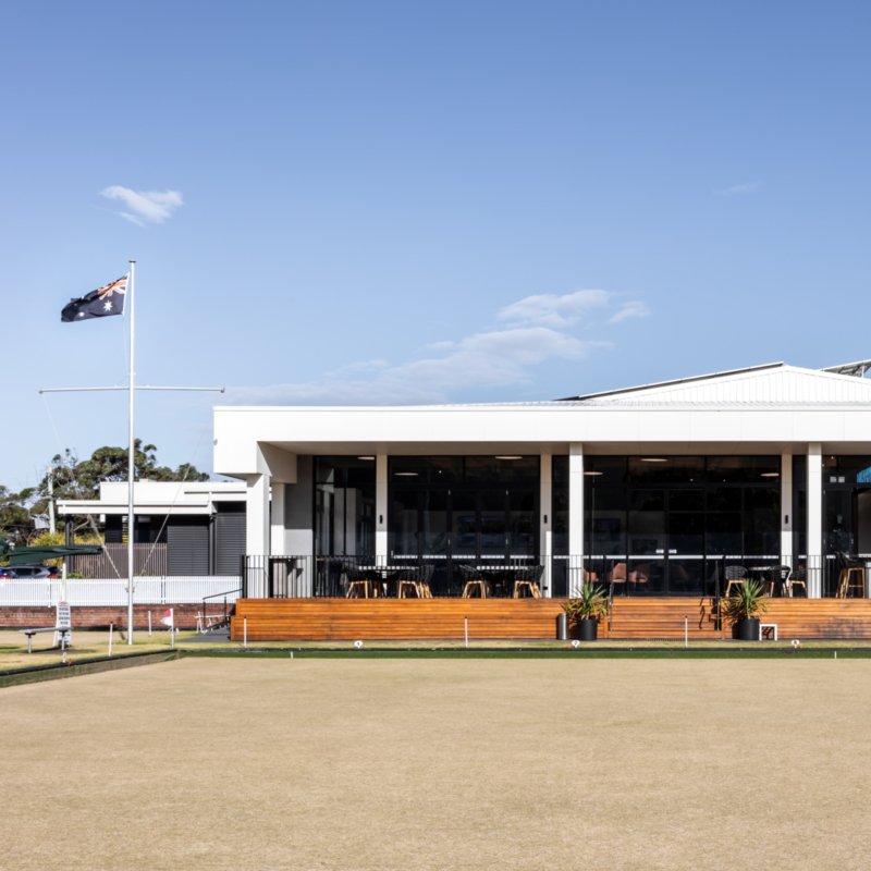 Exterior of Shoalhaven Heads Bowling & Recreation Club with outdoor deck and bowling greens
