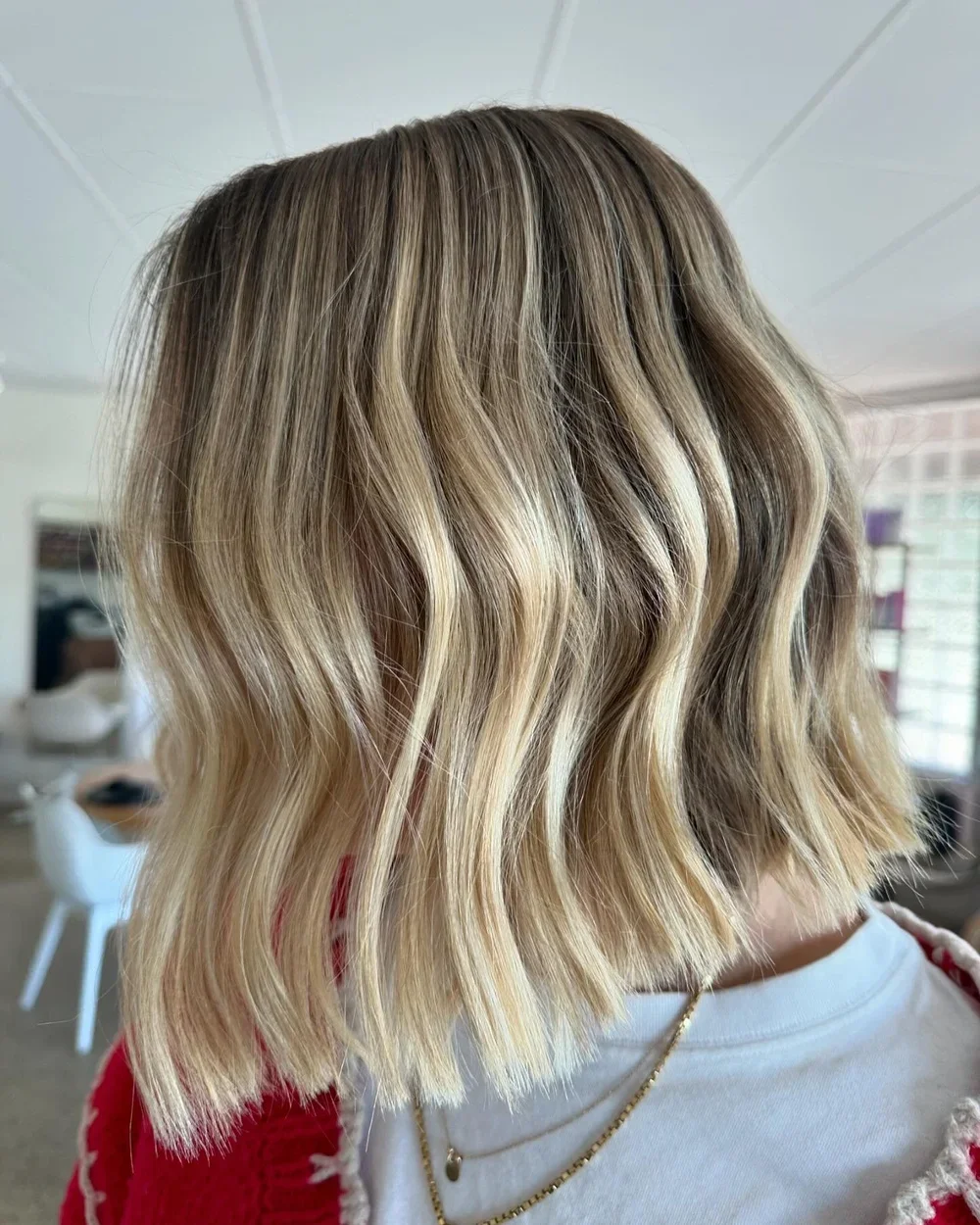 Side view of a textured blonde bob haircut with custom balayage highlights at Silk and Stone Studio.