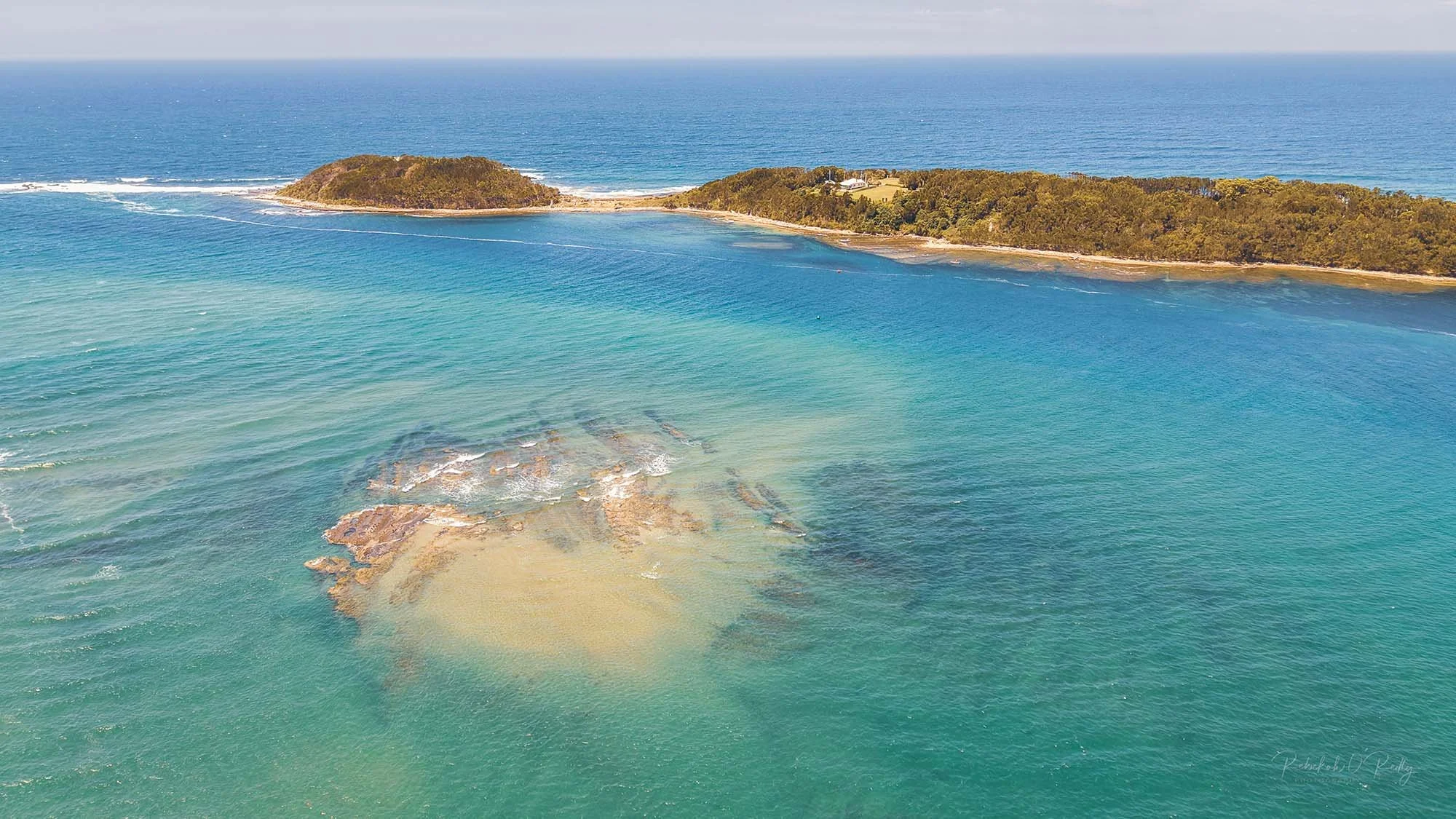 Aerial perspective of the Crookhaven Bar, an essential access point for ocean fishing near Shoalhaven Heads.