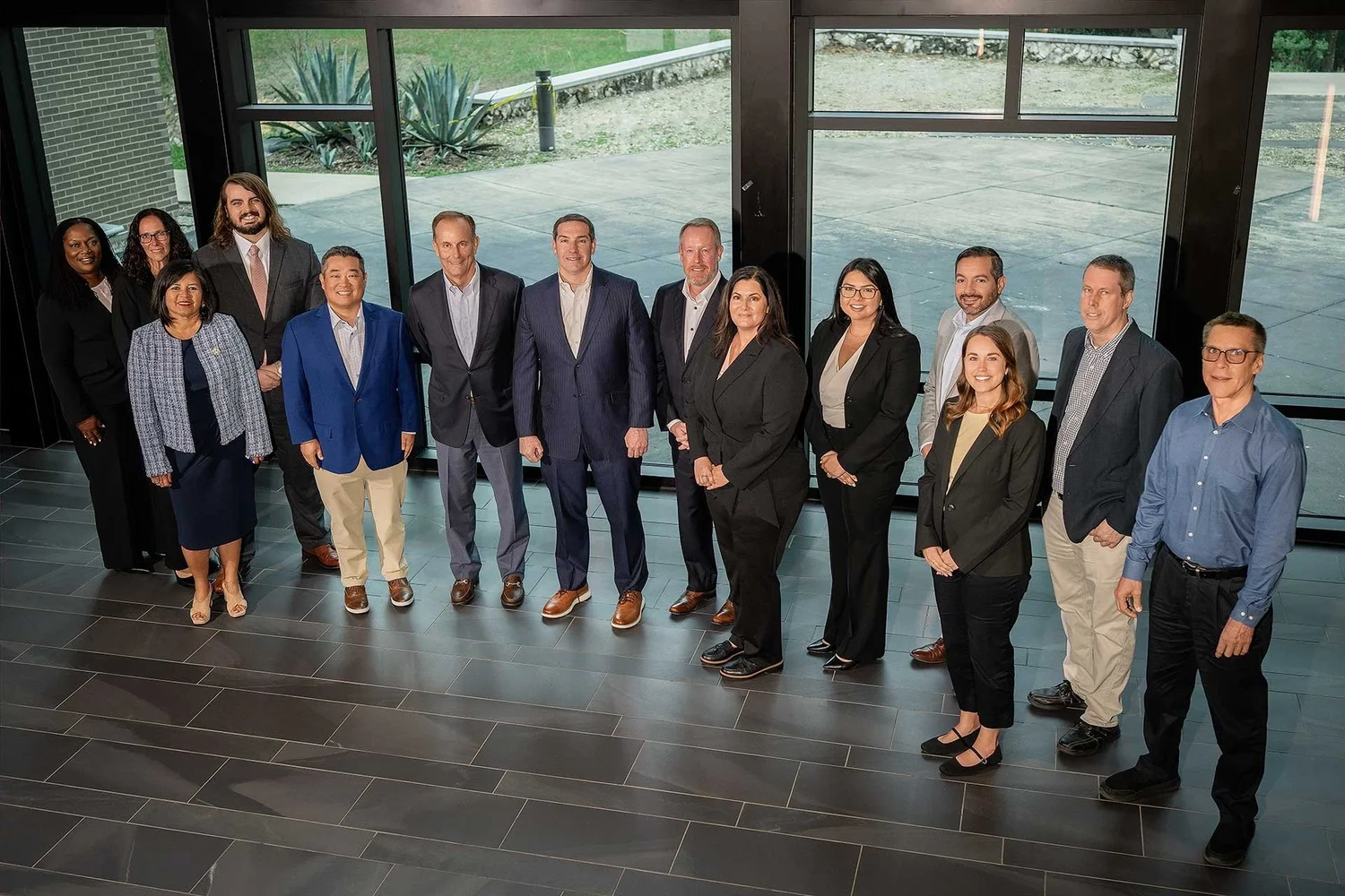 Members of the Orange Insurance team standing together in a bright, modern lobby