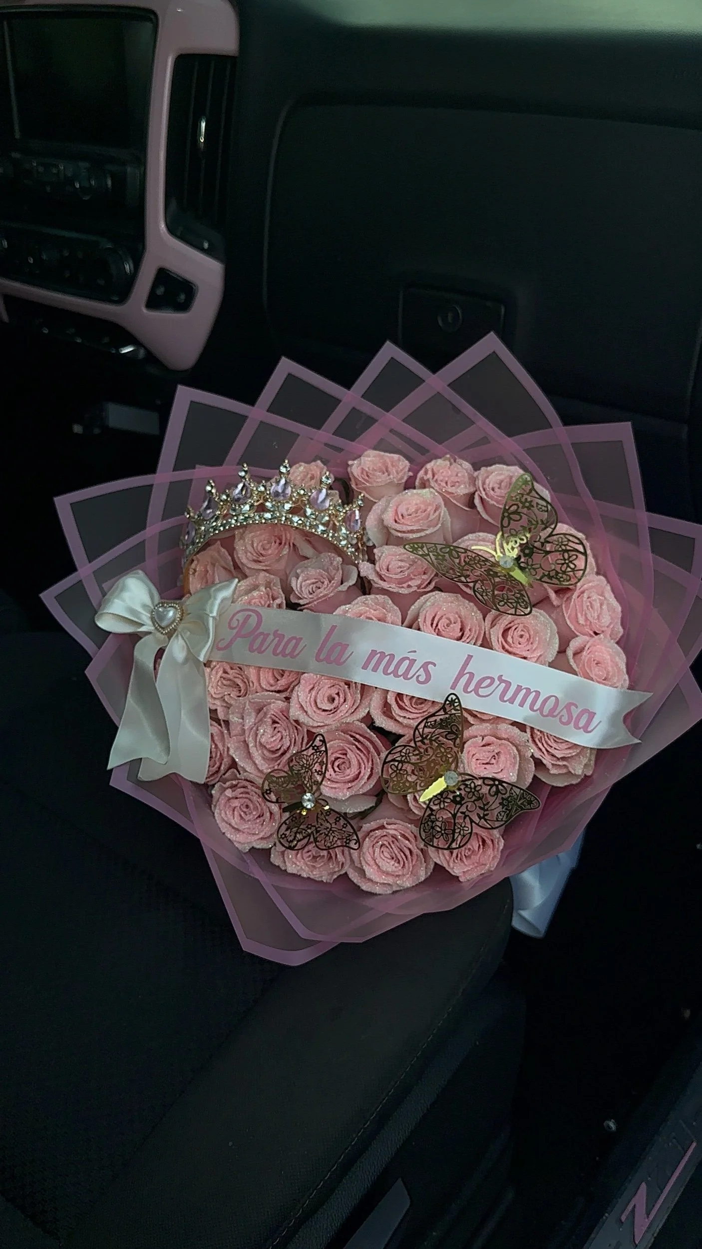 Pink glitter rose bouquet with a message banner, pink crown, gold butterflies, and transparent pink floral wrapping.