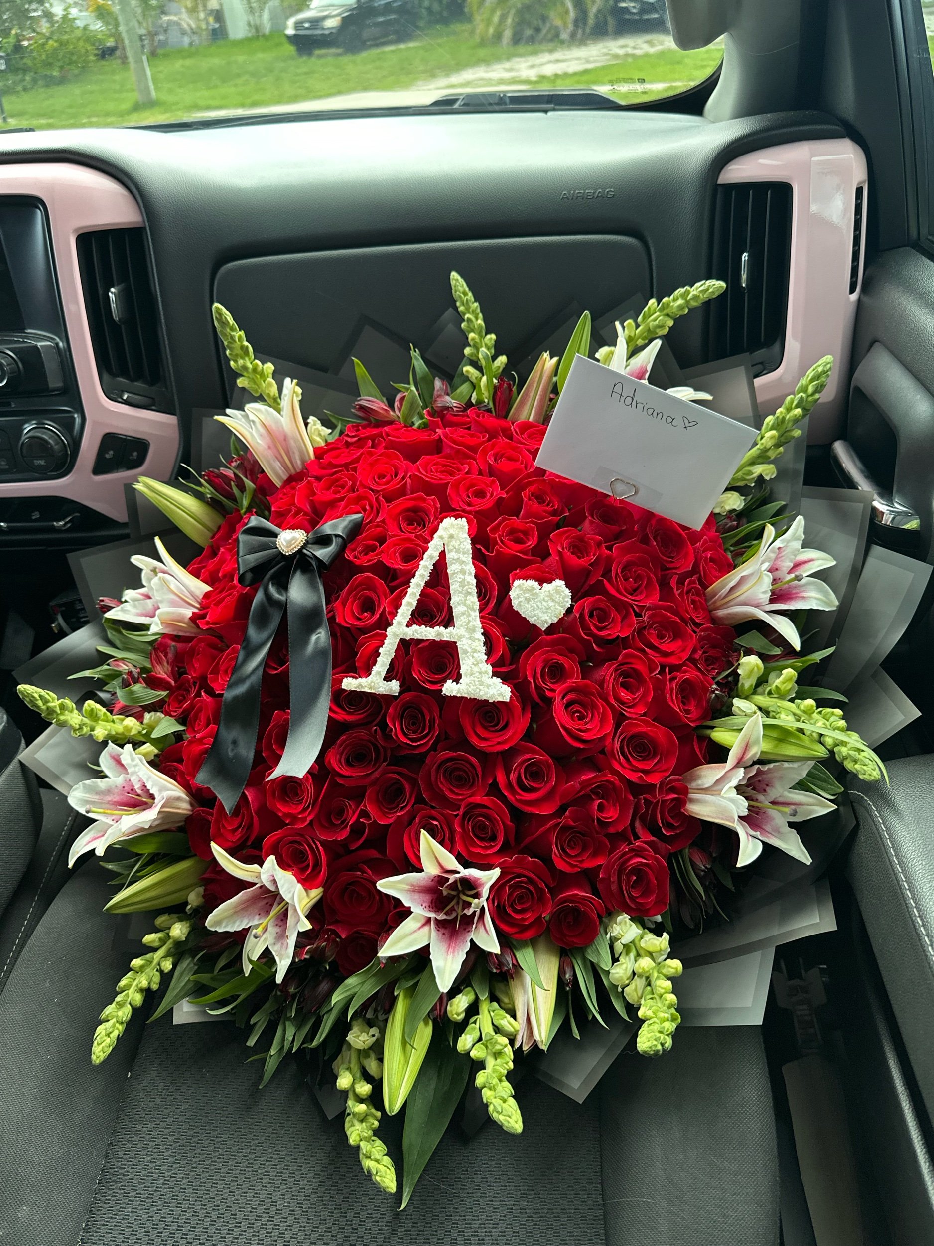 Red rose and lily bouquet with snapdragons, alstroemeria, and a personalized baby’s breath letter.
