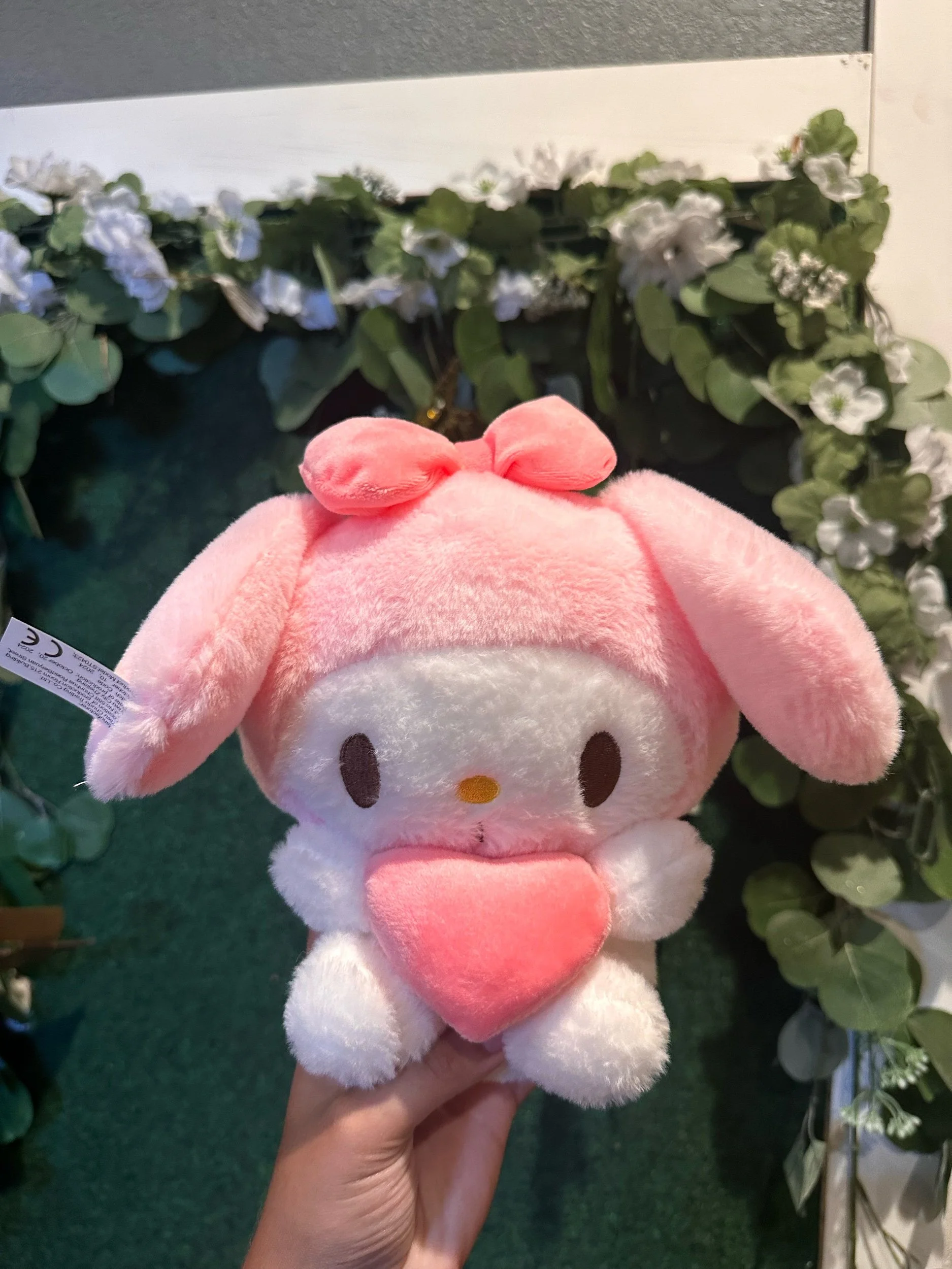 Pink My Melody plush toy with signature bunny ears and hood.