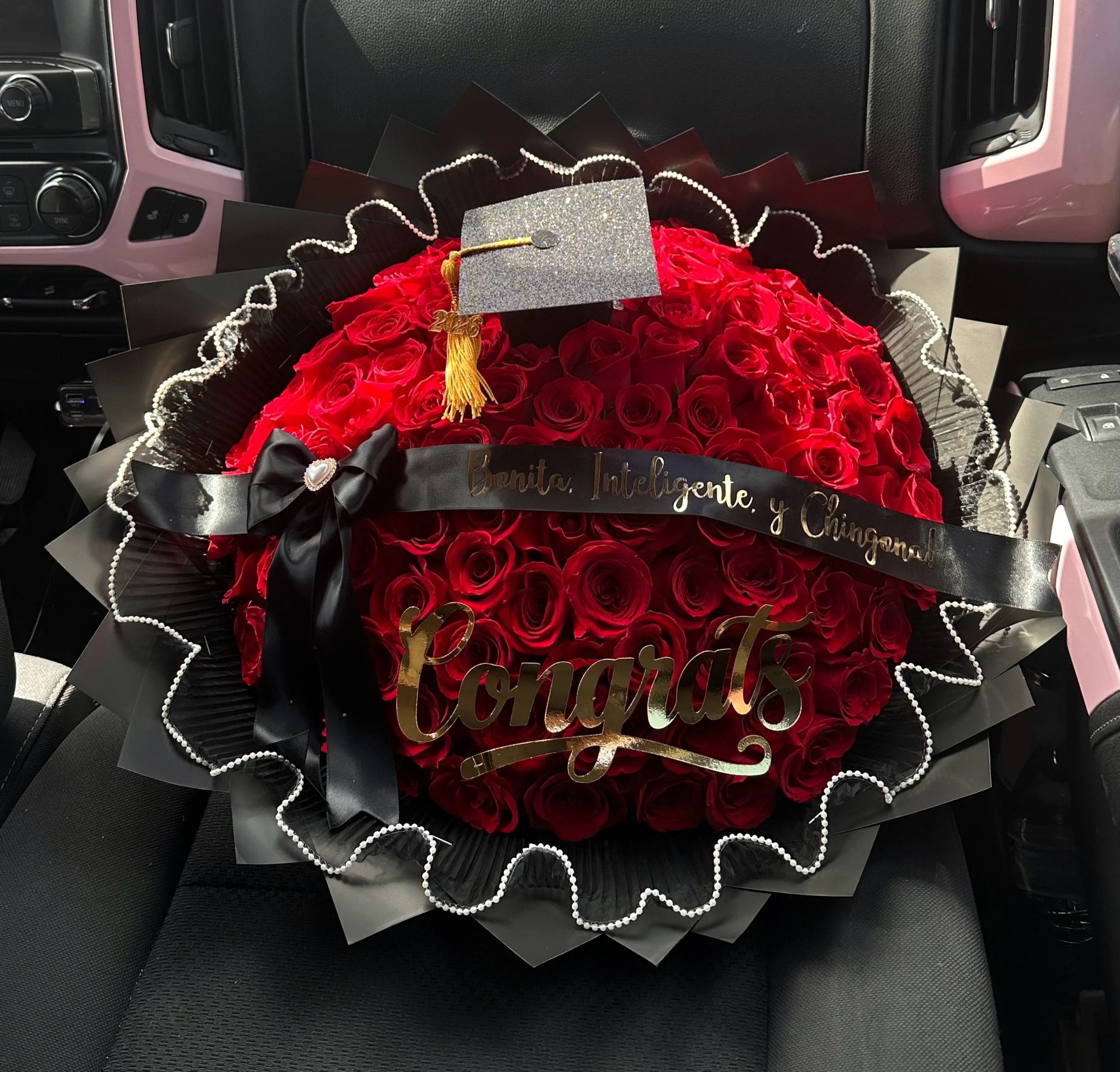 Red rose graduation bouquet with pearl mesh, a personalized message banner, and a “Congrats” topper.