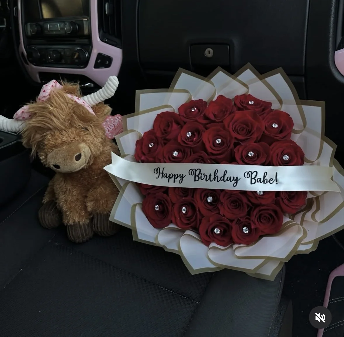 Red rose bouquet accented with diamond embellishments and wrapped in pink waterproof floral paper with gold detailing.