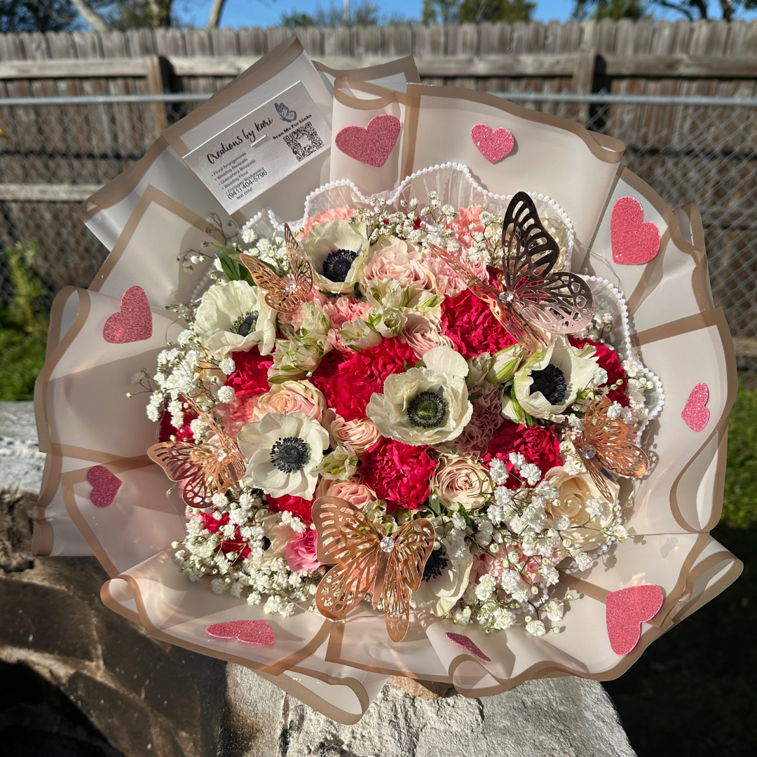 Pink and white rose bouquet with glitter hearts and butterfly accents