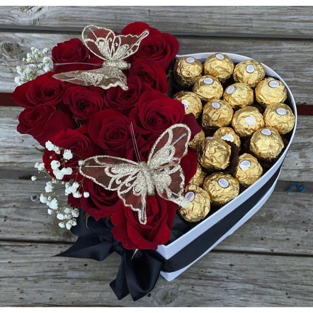 Heart-shaped red rose bouquet with baby’s breath, gold butterflies, and chocolates