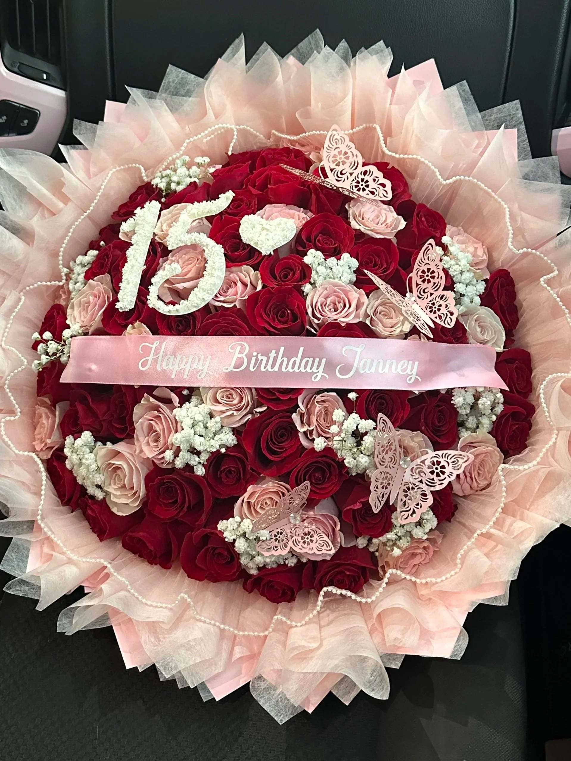 Red and pink rose birthday bouquet with baby’s breath and personalized banner