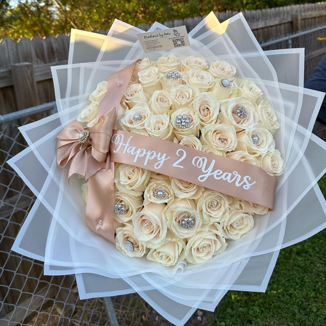 White rose anniversary bouquet with “Happy 2 Years” ribbon