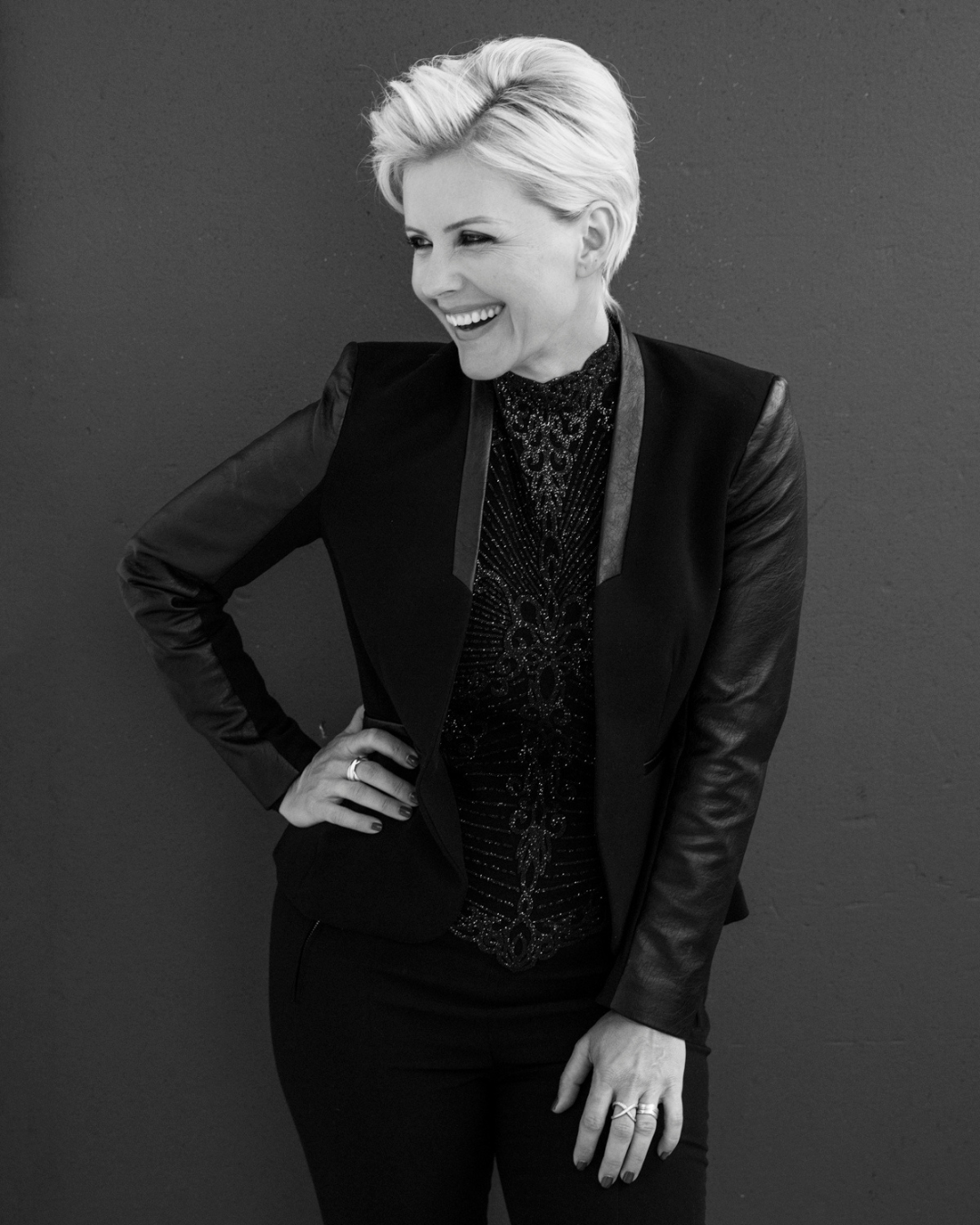 Simona Janek, award-winning boudoir photographer, laughing in a black leather blazer — Giggster Best Boudoir Photographer 2021