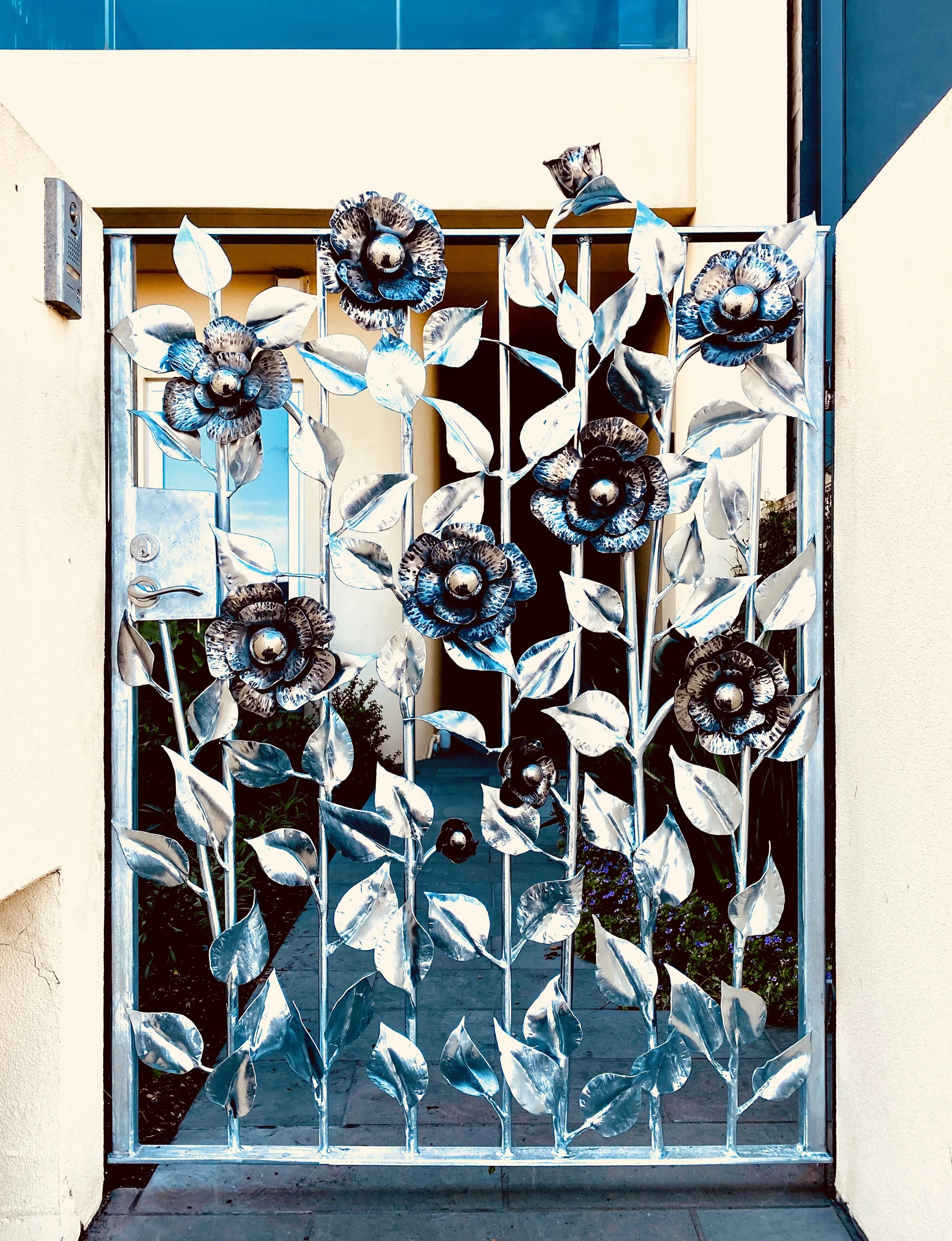 Forged Stainless Steel Gate Floral Embellishment by artist and blacksmith David Wood.