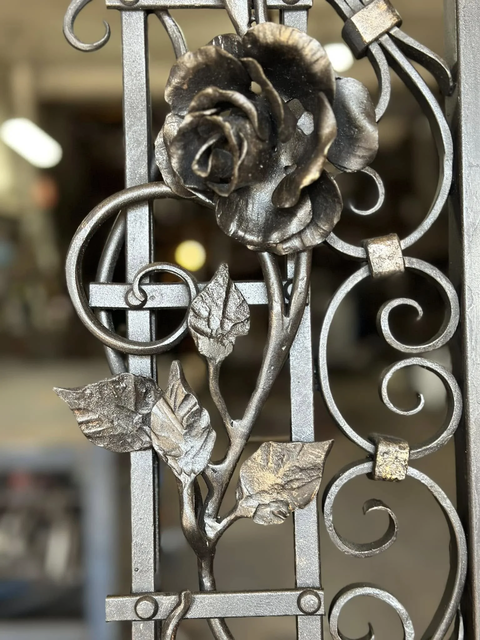 Wrought iron security door by David Wood of Bent Metal with rose and scroll details.