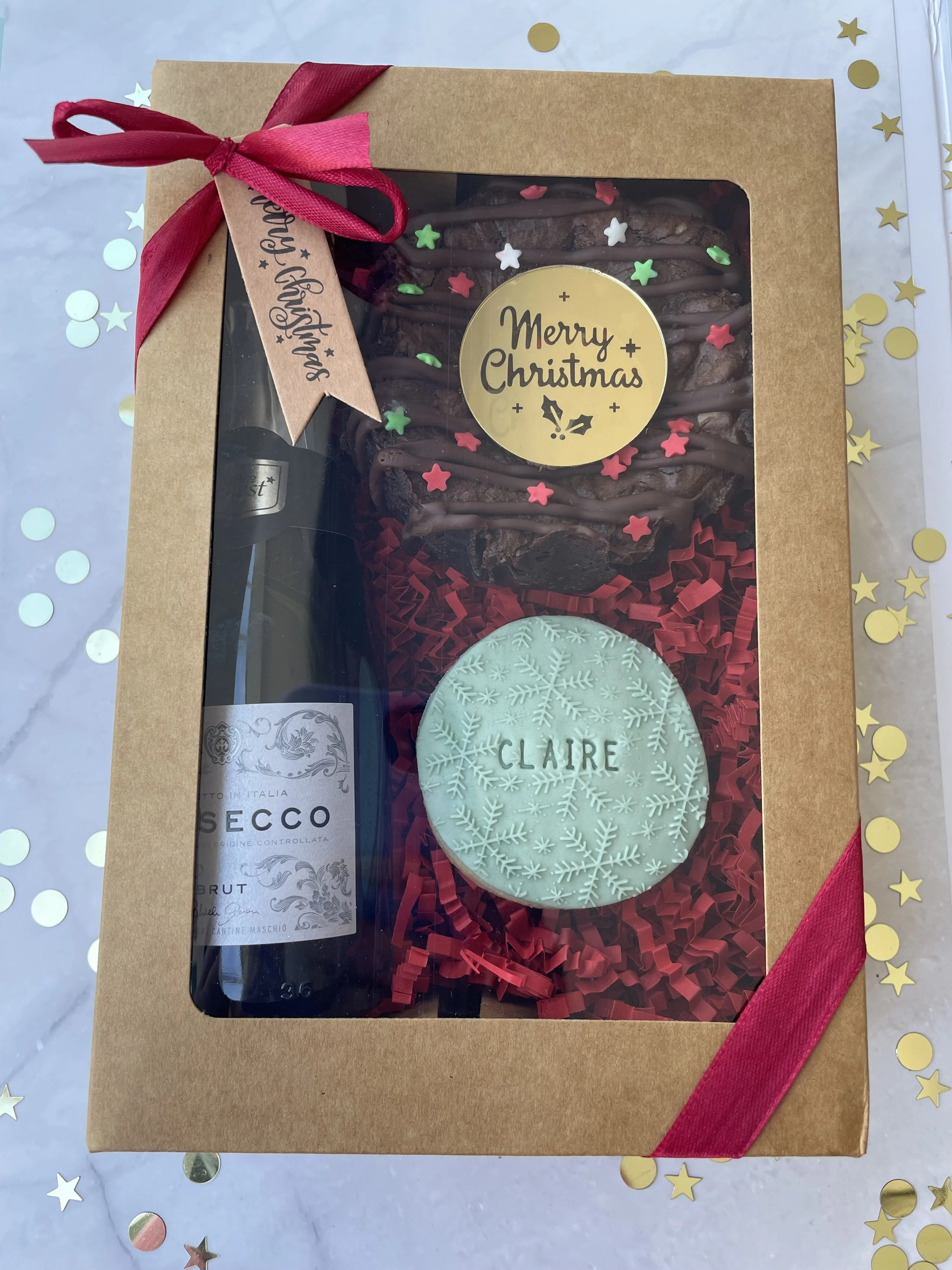 Individual Hamper - £15.
Includes: Mini bottle of Fizz, a Triple Choc Brownie round (serves approx 4 portions) & a Personalised Shortbread Biscuit.