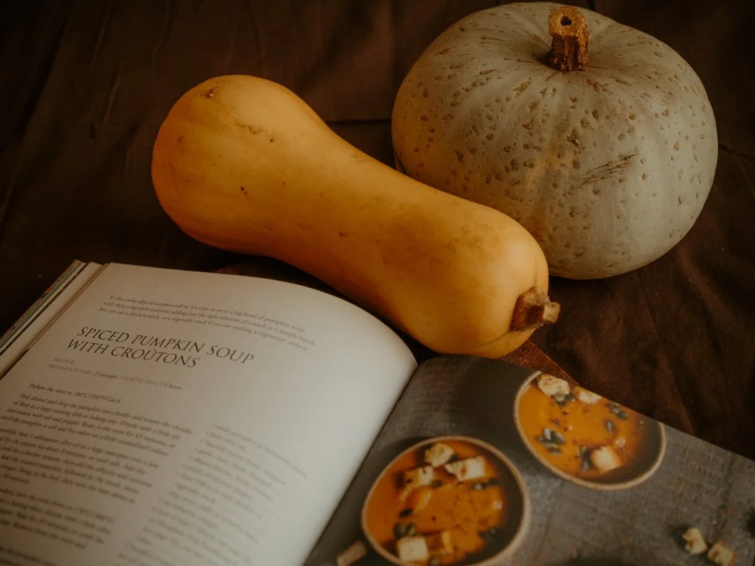 Recipe for spiced pumpkin soup from Roger Saul's Spelt cookbook, displayed alongside a butternut squash and Crown Prince squash.