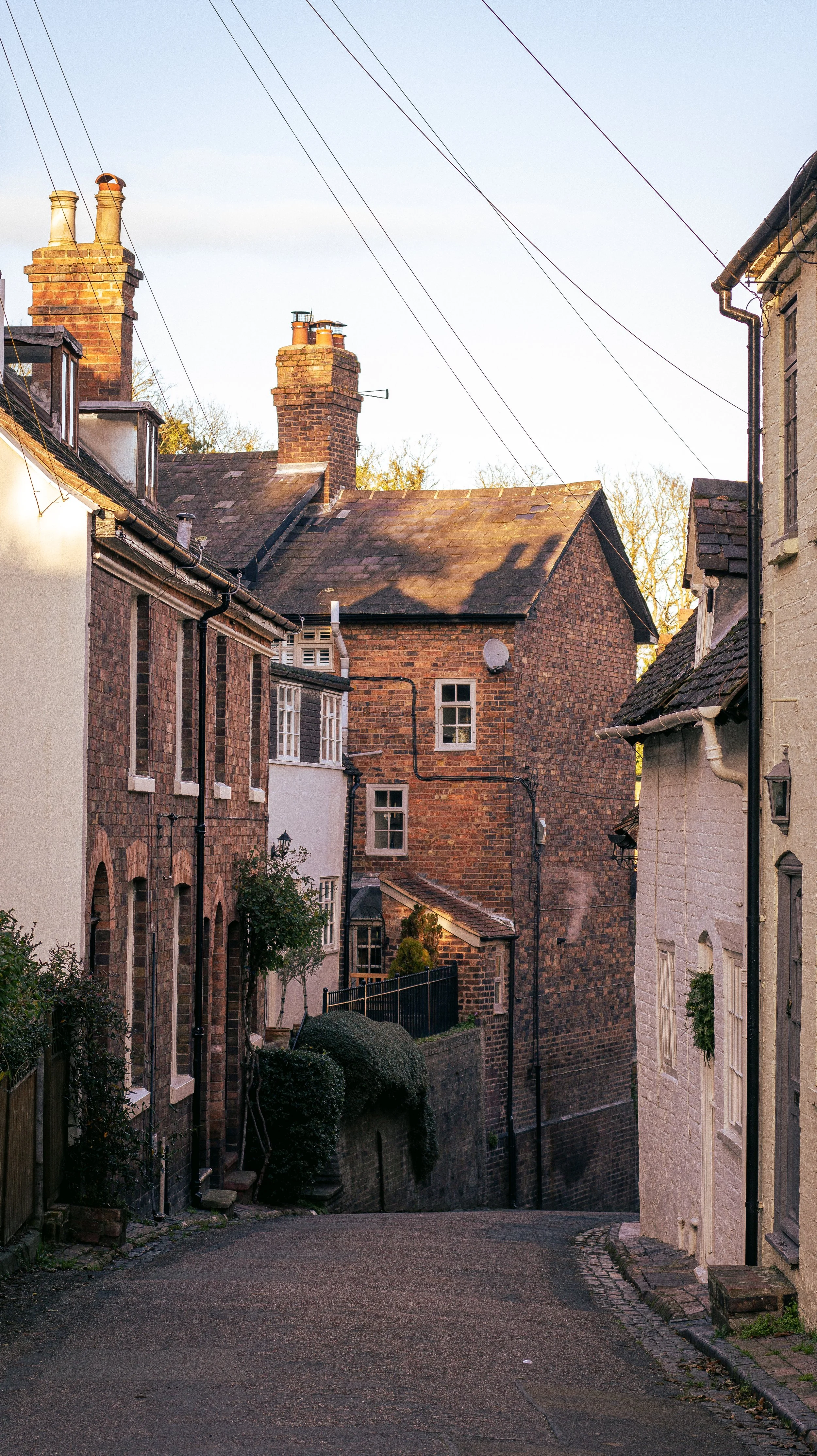 Quiet English village street with traditional houses, simple slow living scene