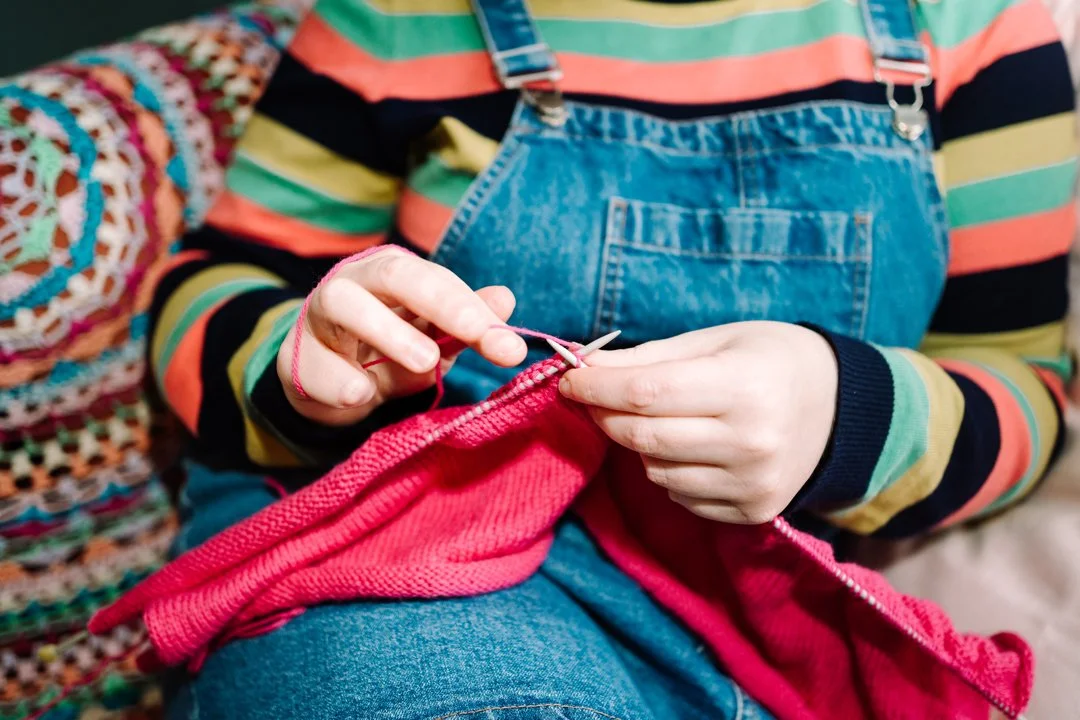 Rhiannon Adler knitting indoors as part of a slower, more mindful and creative lifestyle.
